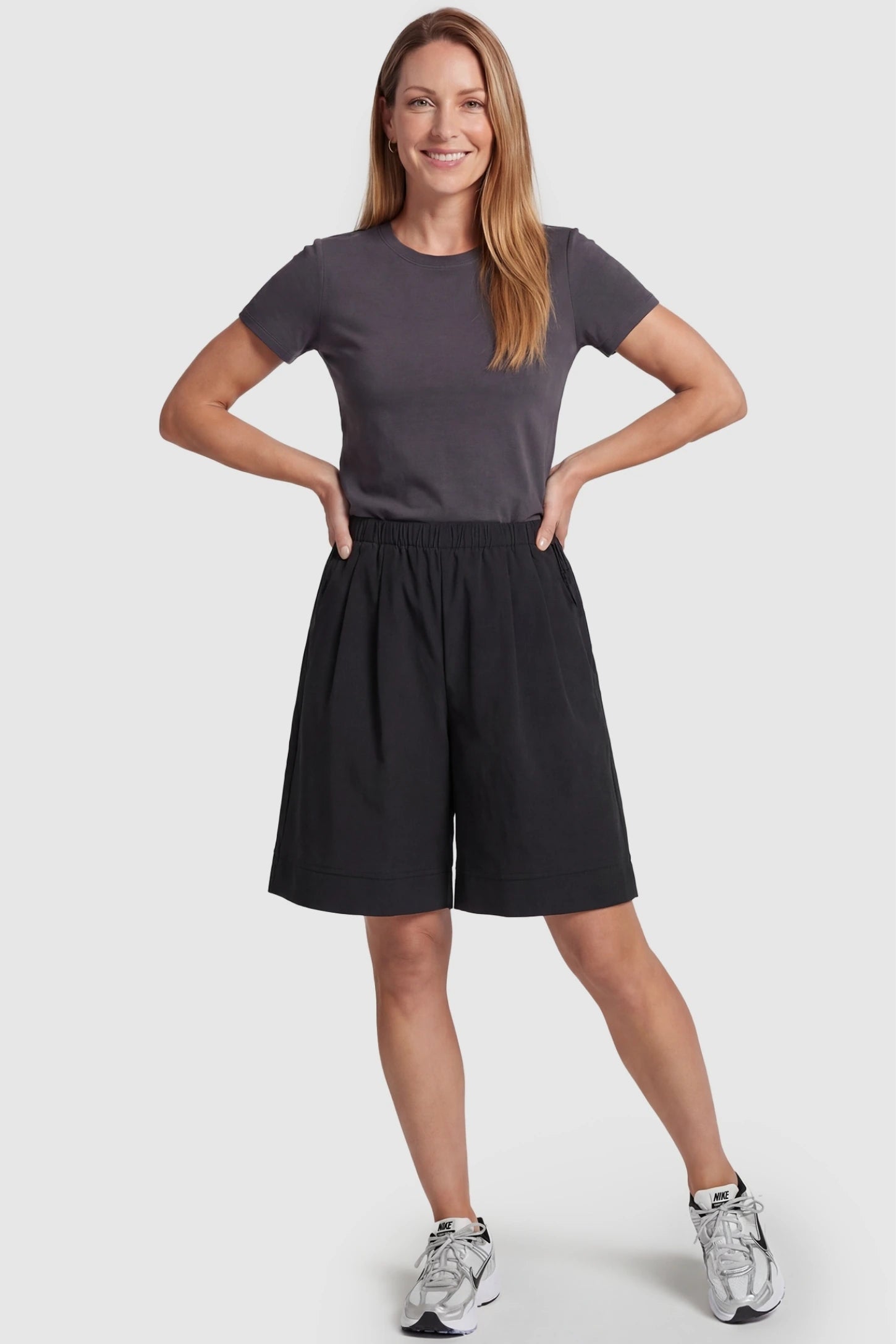 Pocketed Side Drawstring Maternity Shorts Black Elasticated Waist Wide Leg Maternity Shorts featuring a versatile lounge-to-street design on a postpartum model, front view.