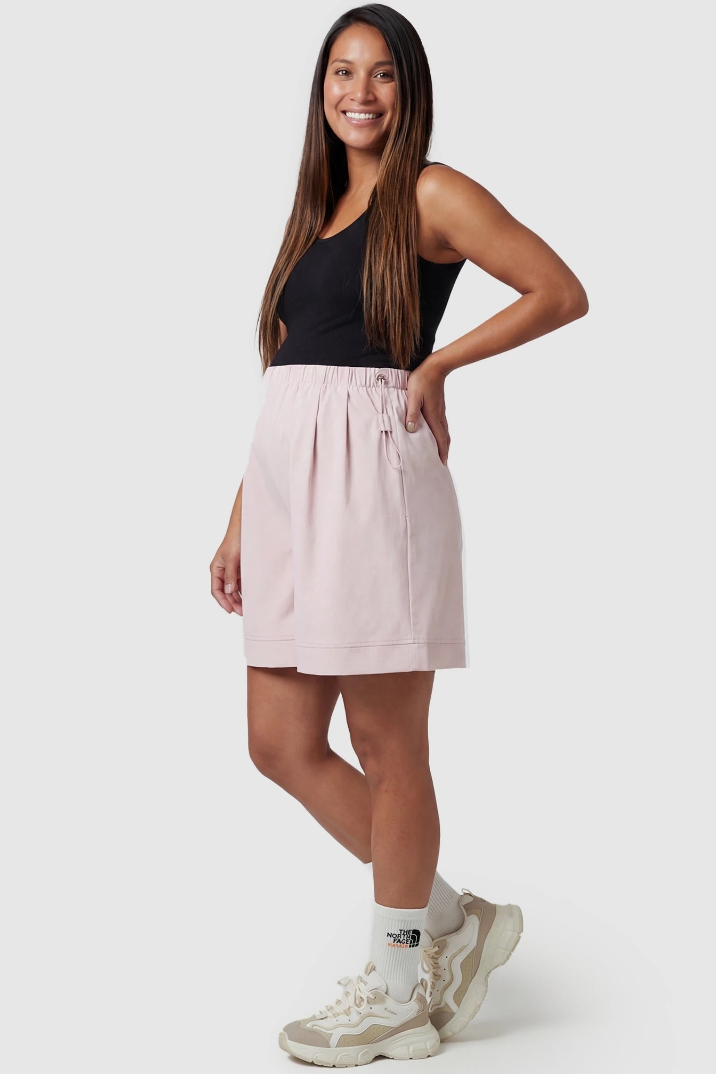 Pocketed Side Drawstring Maternity Shorts Front view of Light Pink Elasticated Waist Maternity Shorts featuring soft-touch fabric on a pregnant model.