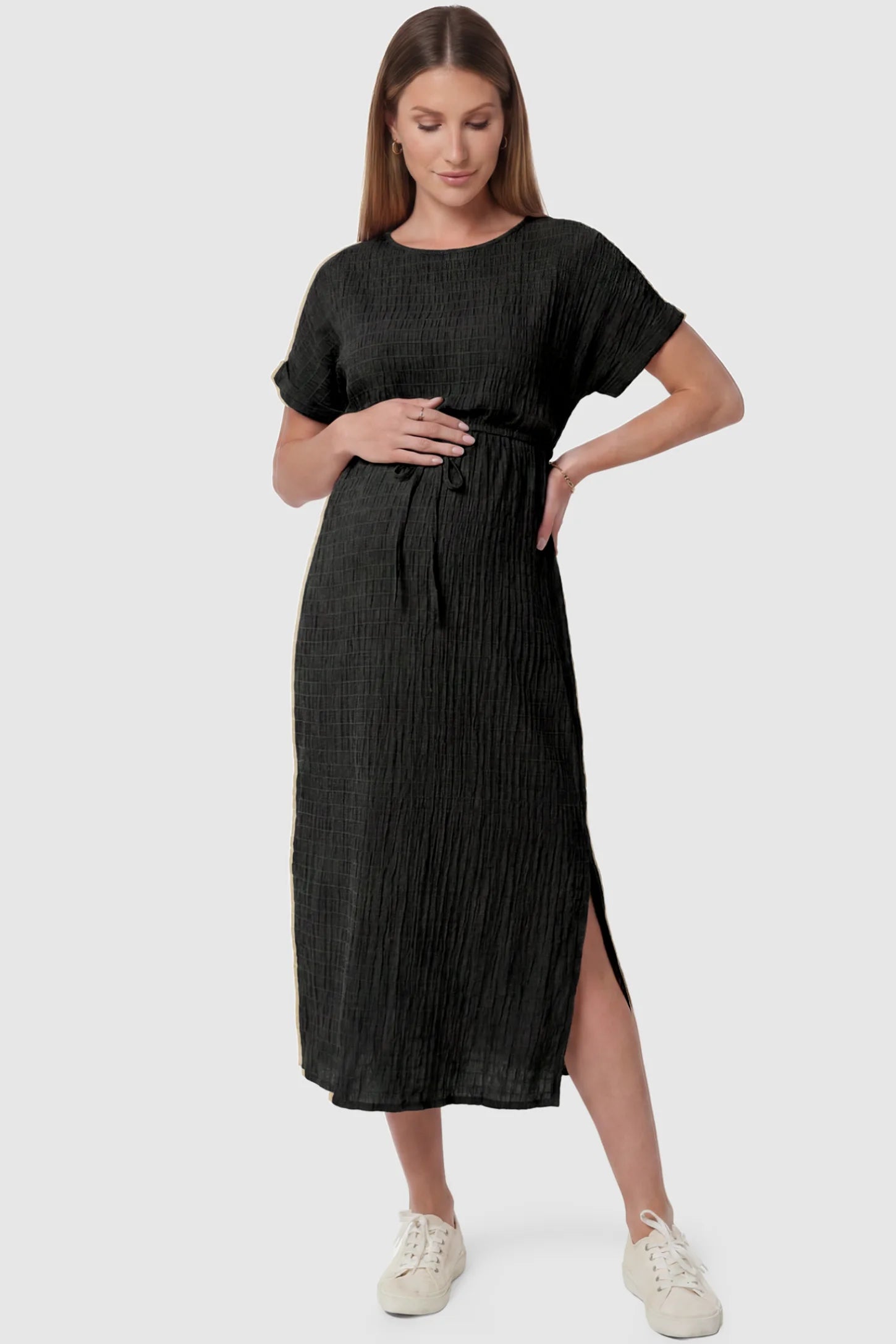 Empire Waist Round Neck Maternity Midi Dress Empire Waist Round Neck Maternity Midi Dress in Black featuring elasticated waistband with a decorative tie detail on a pregnant model, front view.