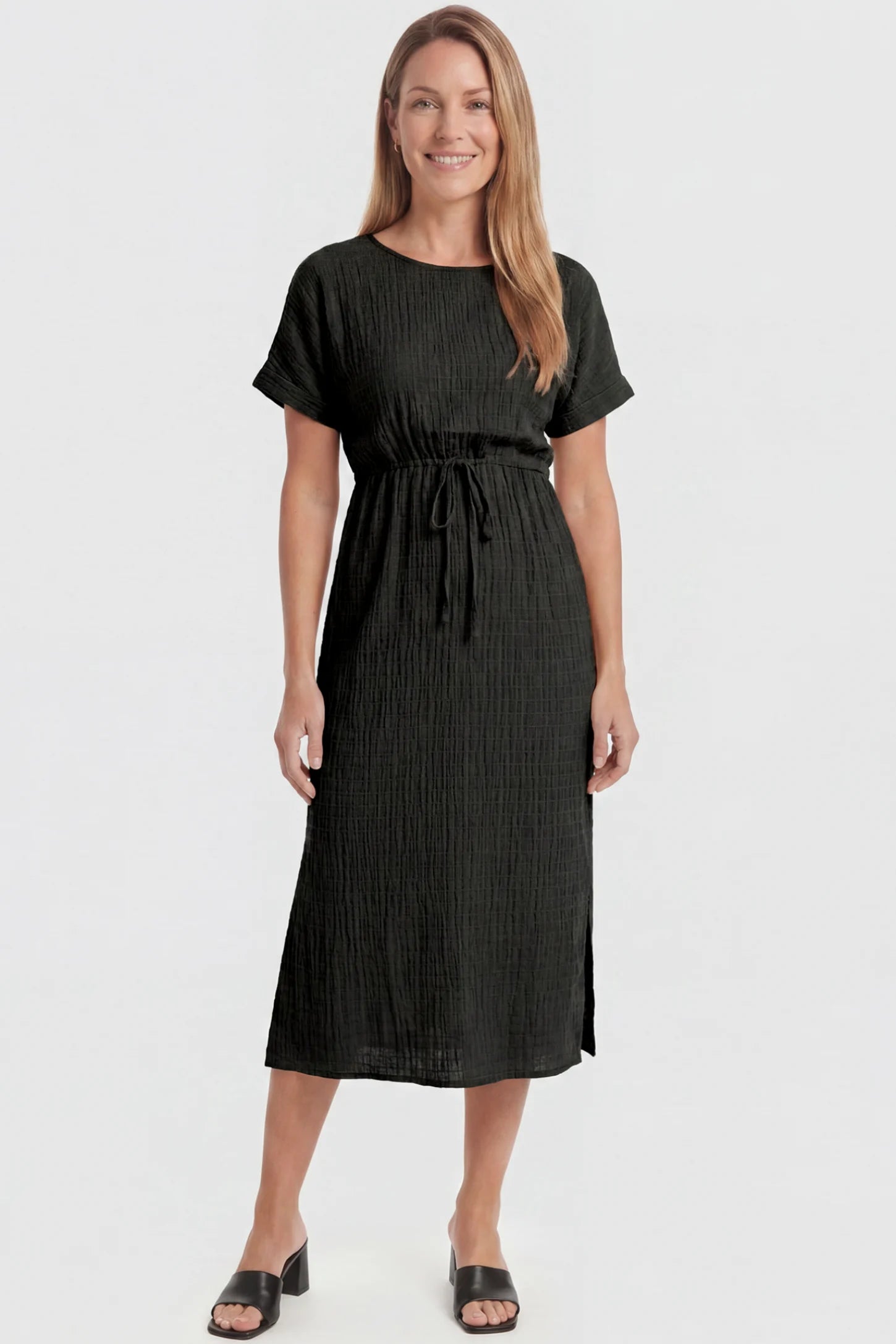 Empire Waist Round Neck Maternity Midi Dress Empire Waist Round Neck Maternity Midi Dress in Black featuring elasticated waistband with a decorative tie detail on a postpartum model, front view.