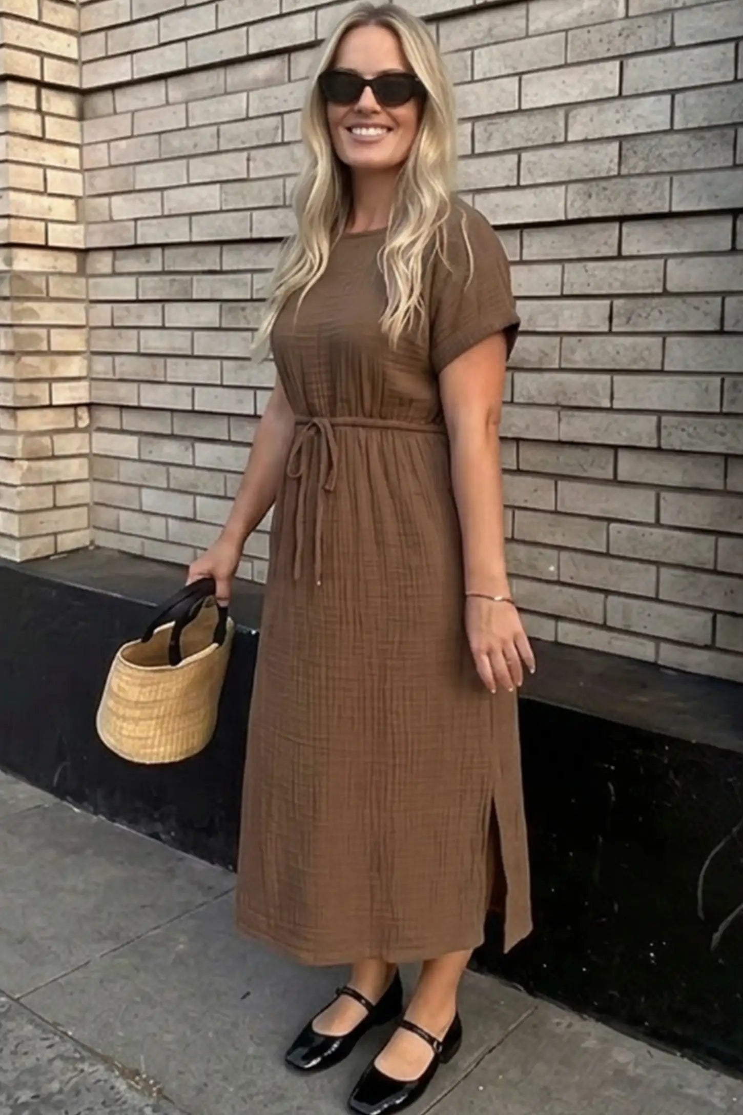Empire Waist Round Neck Maternity Midi Dress Empire Waist Round Neck Maternity Midi Dress in Brown featuring elasticated waistband with a decorative tie detail on a plus size pregnant woman in outdoor setting, front view.