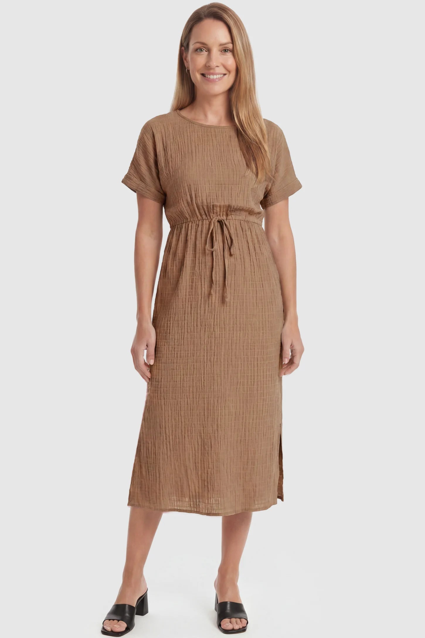 Empire Waist Round Neck Maternity Midi Dress Empire Waist Round Neck Maternity Midi Dress in Brown featuring elasticated waistband with a decorative tie detail on a postpartum model, front view.