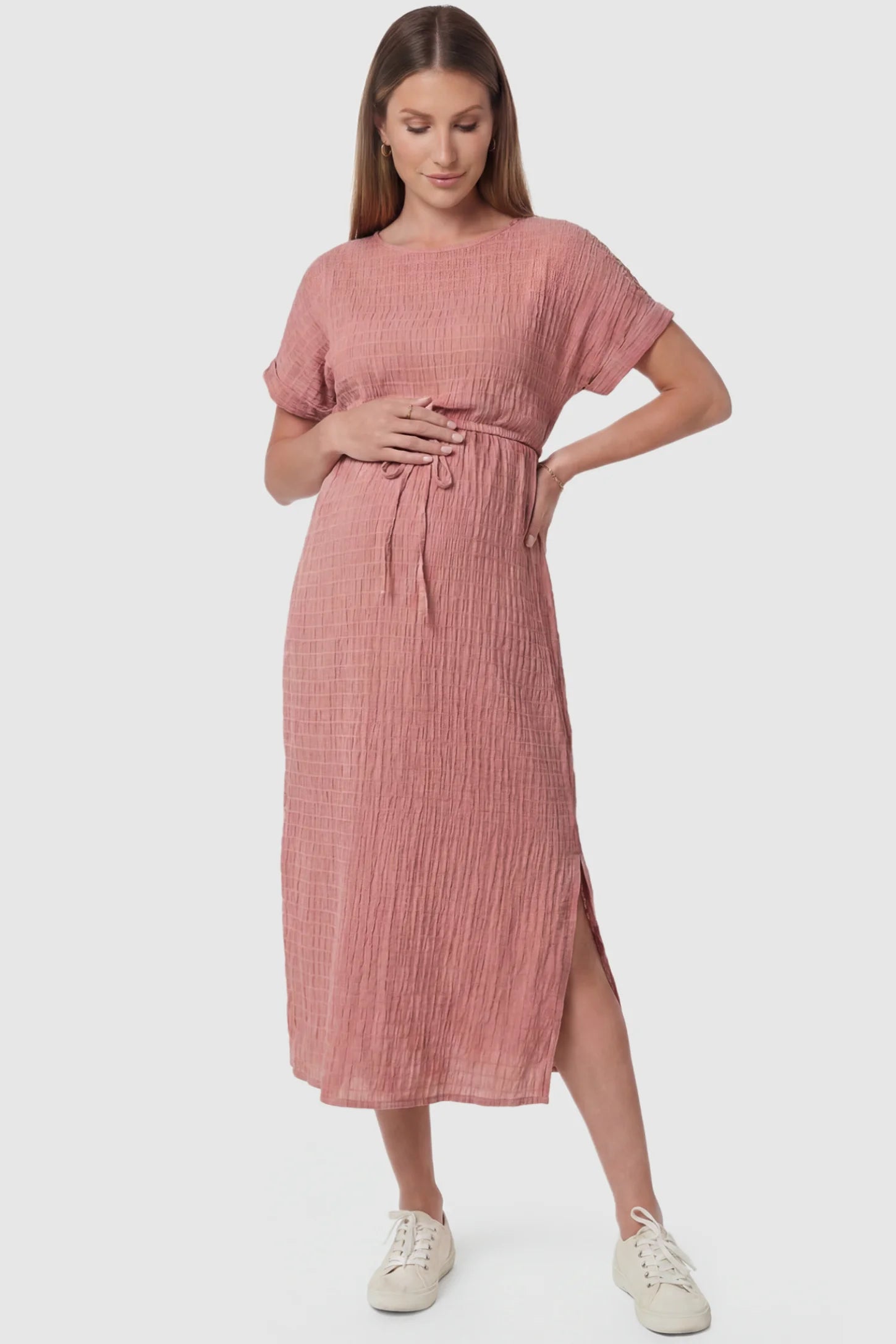 Empire Waist Round Neck Maternity Midi Dress in Pink featuring elasticated waistband with a decorative tie detail on a pregnant model, front view.