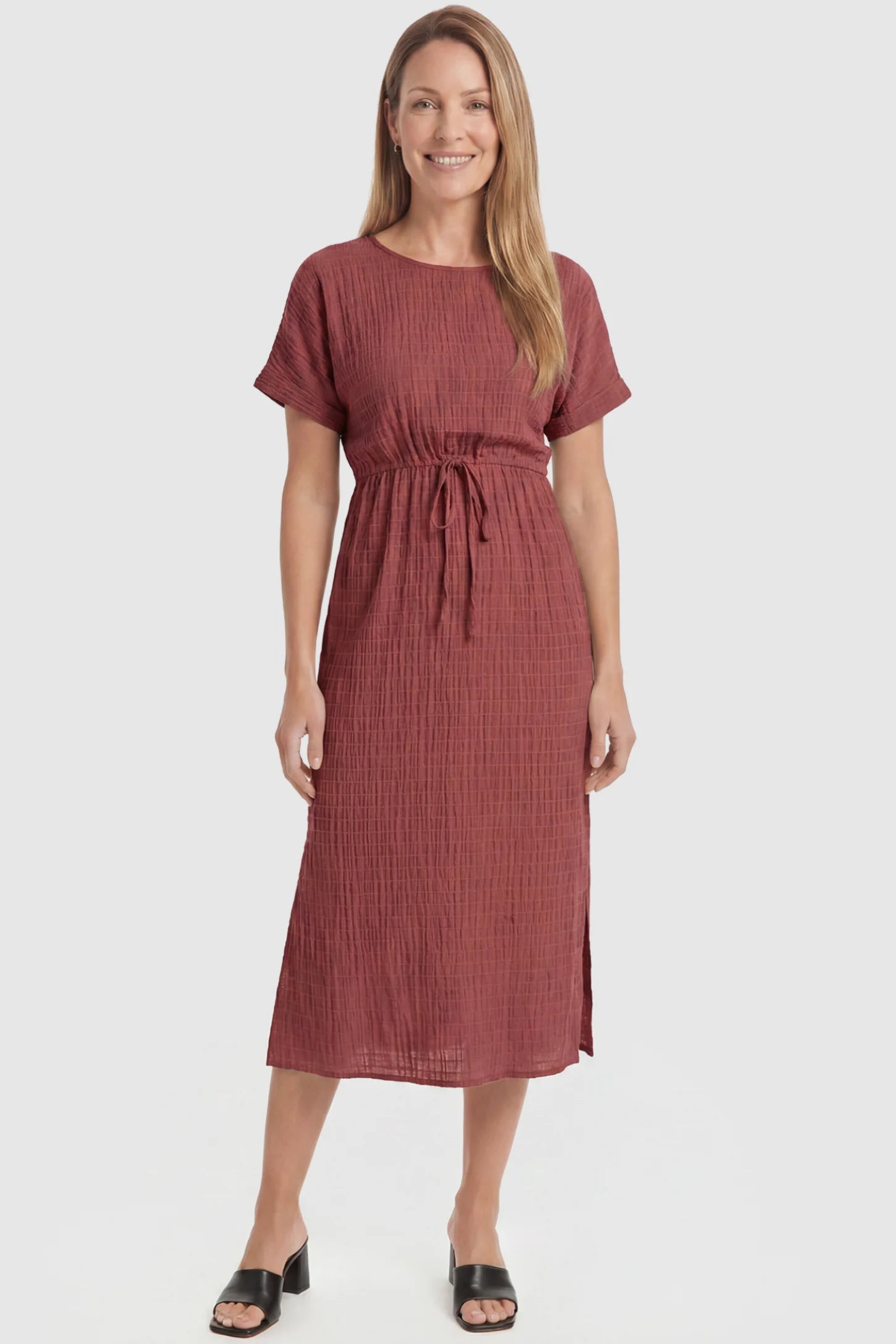 Empire Waist Round Neck Maternity Midi Dress Empire Waist Round Neck Maternity Midi Dress in Wine Red featuring elasticated waistband with a decorative tie detail on a postpartum model, front view.
