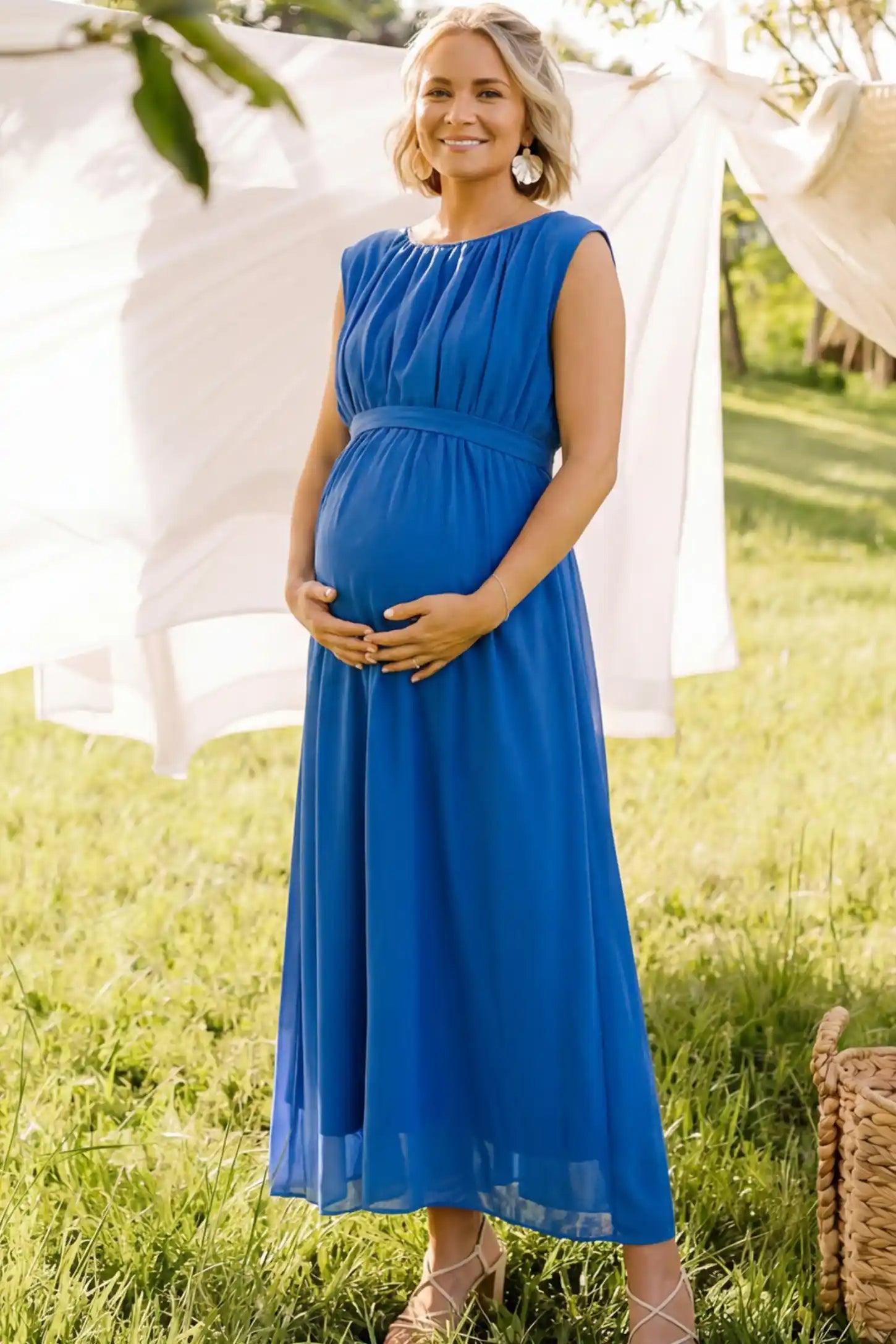 Empire Waist Tie-Front Sleeveless Maternity Maxi Dress in Blue featuring a tie front and empire waist on a pregnant model front view.