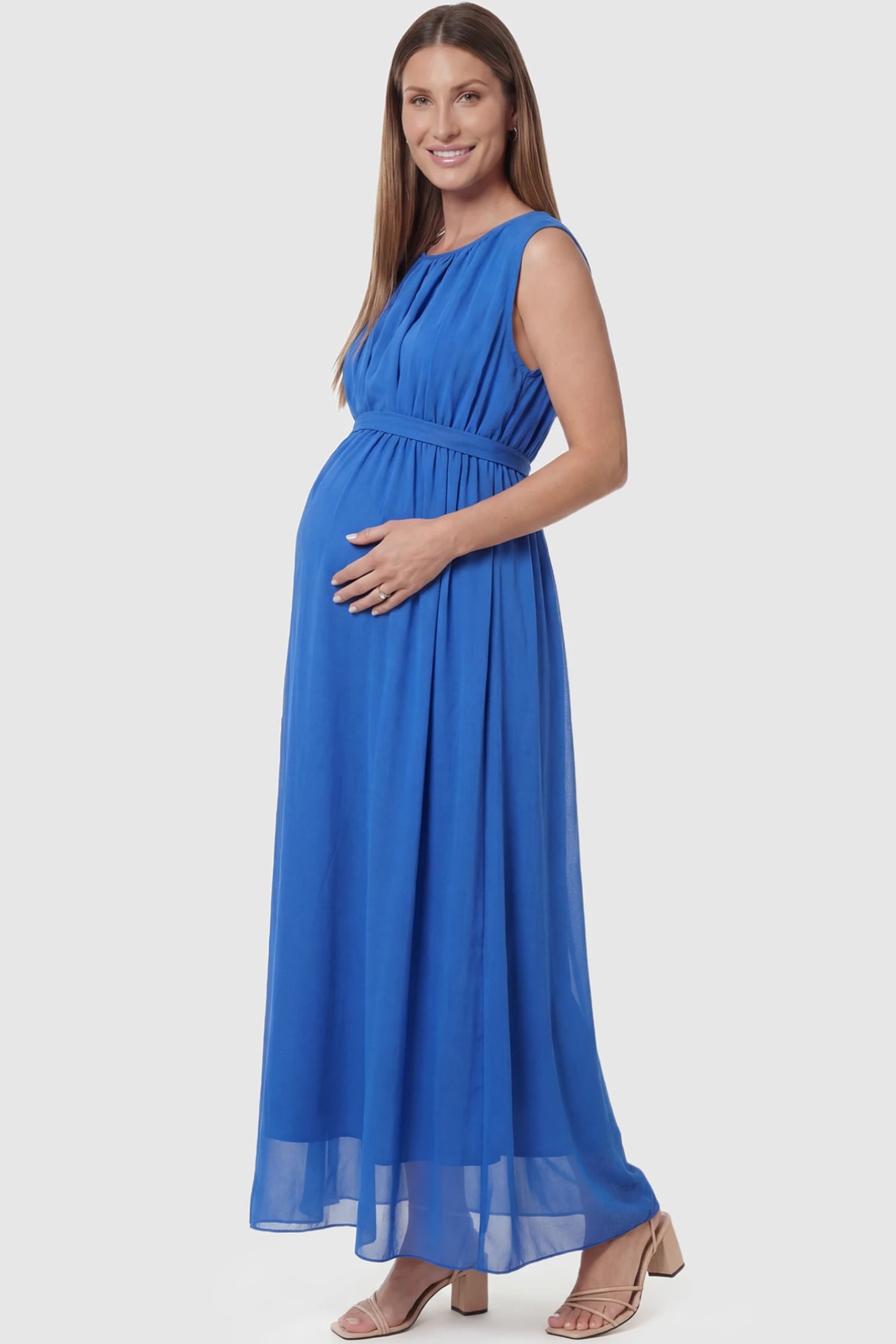 Empire Waist Tie-Front Sleeveless Maternity Maxi Dress Empire Waist Tie-Front Sleeveless Maternity Maxi Dress in Blue featuring a tie front and empire waist on a pregnant model side view.