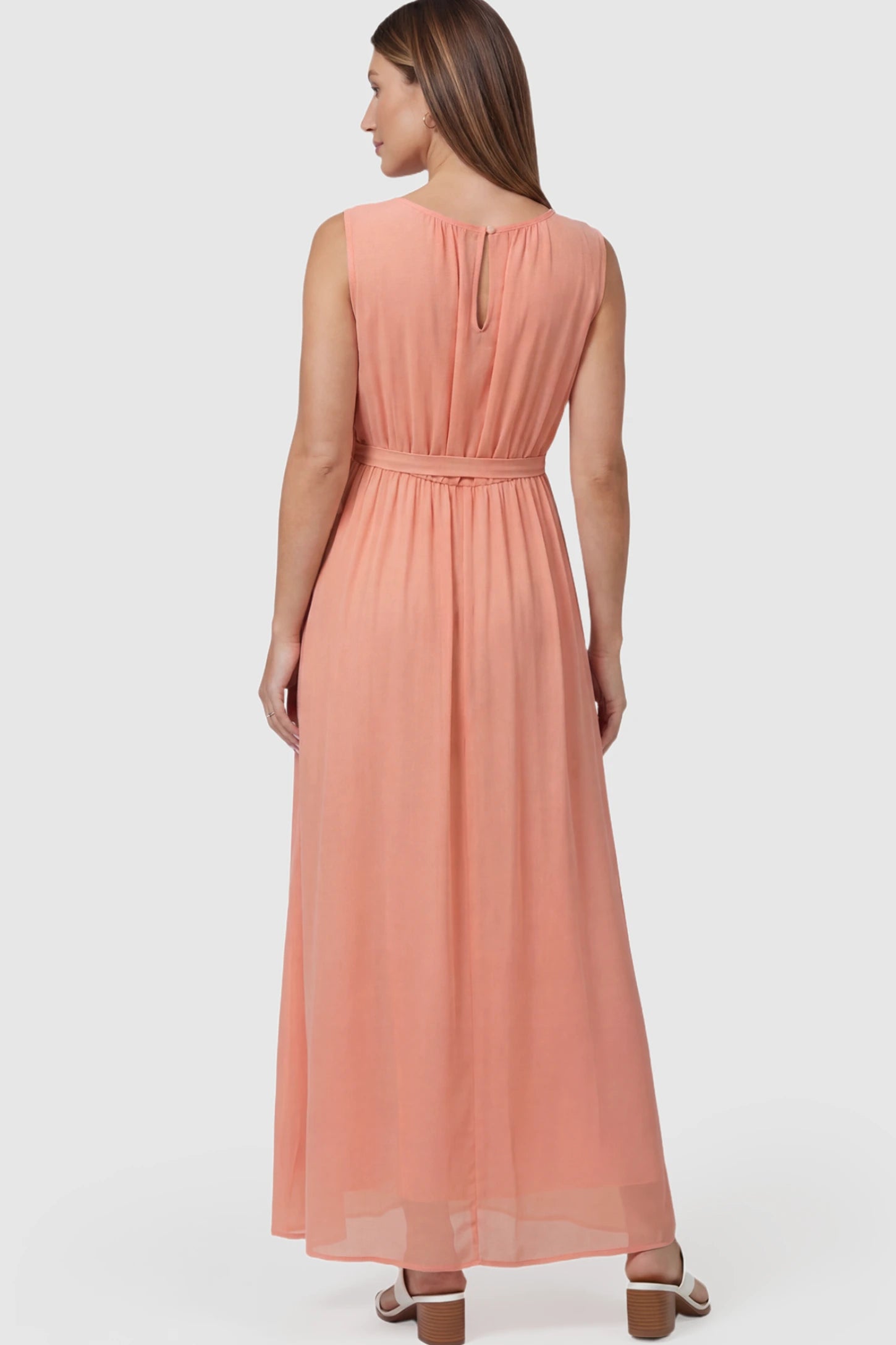 Empire Waist Tie-Front Sleeveless Maternity Maxi Dress Empire Waist Tie-Front Sleeveless Maternity Maxi Dress in Pink featuring adjustable tie and empire waist on a pregnant model back view.