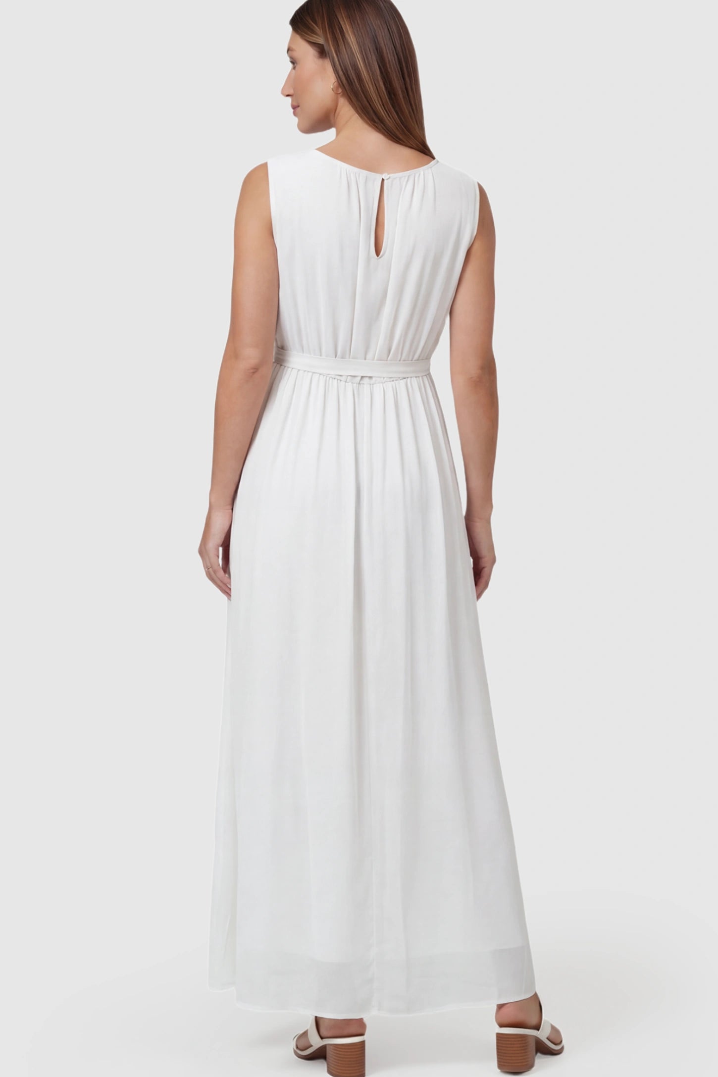 Empire Waist Tie-Front Sleeveless Maternity Maxi Dress Empire Waist Tie-Front Sleeveless Maternity Maxi Dress in White featuring adjustable tie and empire waist on a pregnant model back view.