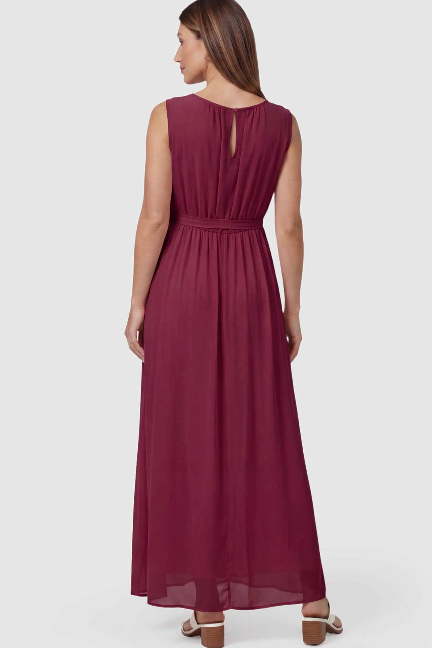 Empire Waist Tie-Front Sleeveless Maternity Maxi Dress Empire Waist Tie-Front Sleeveless Maternity Maxi Dress in Wine Red featuring adjustable tie and empire waist on a pregnant model back view.