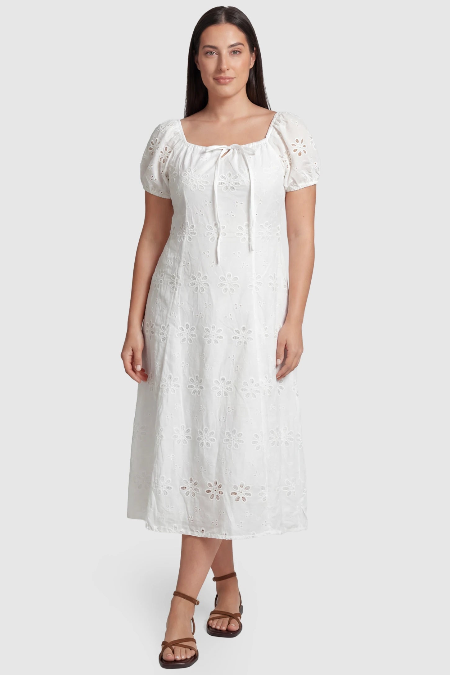Eyelet Embroidered Short Sleeve Maternity Midi Dress Eyelet Embroidered Short Sleeve Maternity Midi Dress in white featuring a square neckline and drawstring waist on a plus size pregnant model, front view.