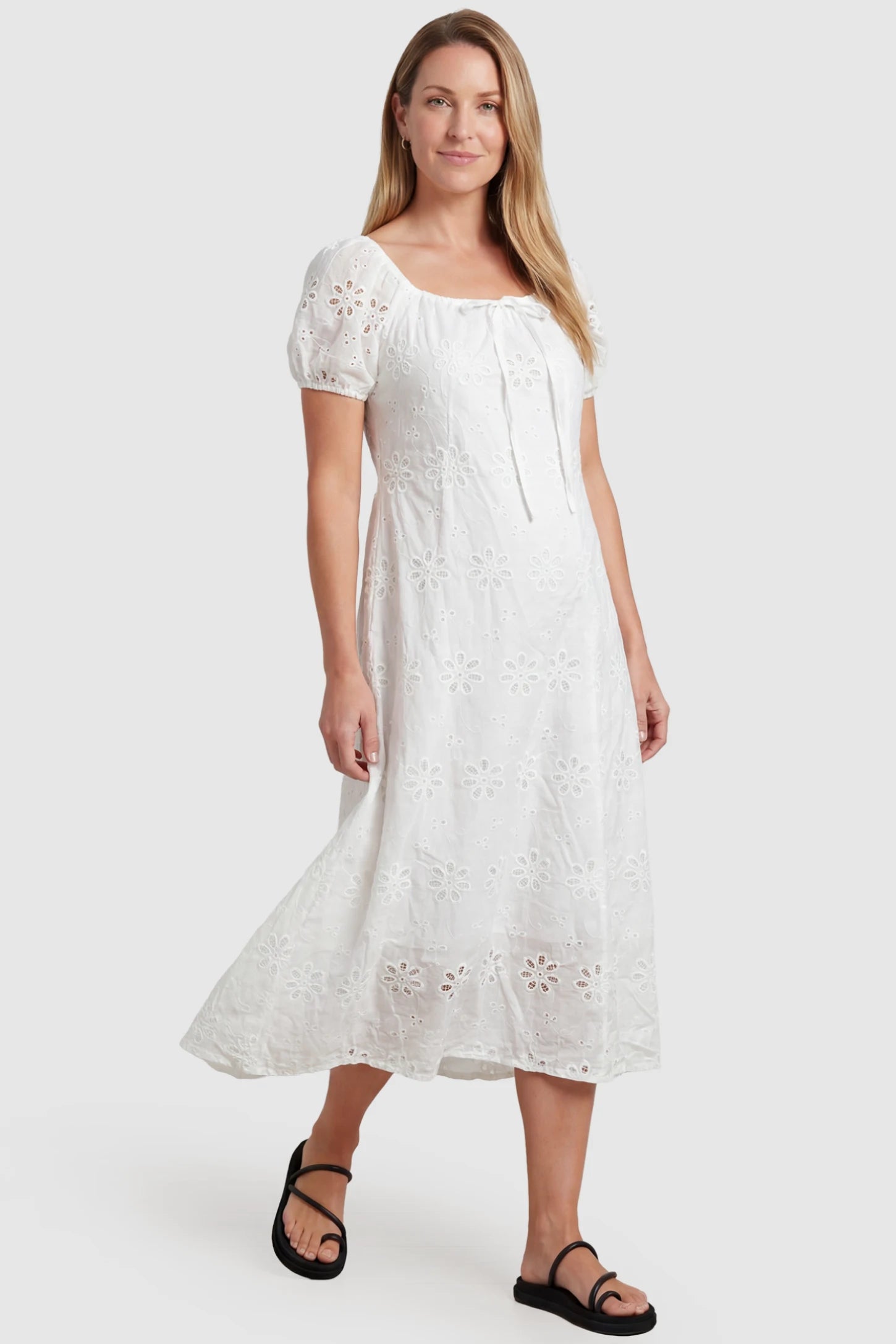 Eyelet Embroidered Short Sleeve Maternity Midi Dress Eyelet Embroidered Short Sleeve Maternity Midi Dress in white featuring a square neckline and drawstring waist on a postpartum model, front view.