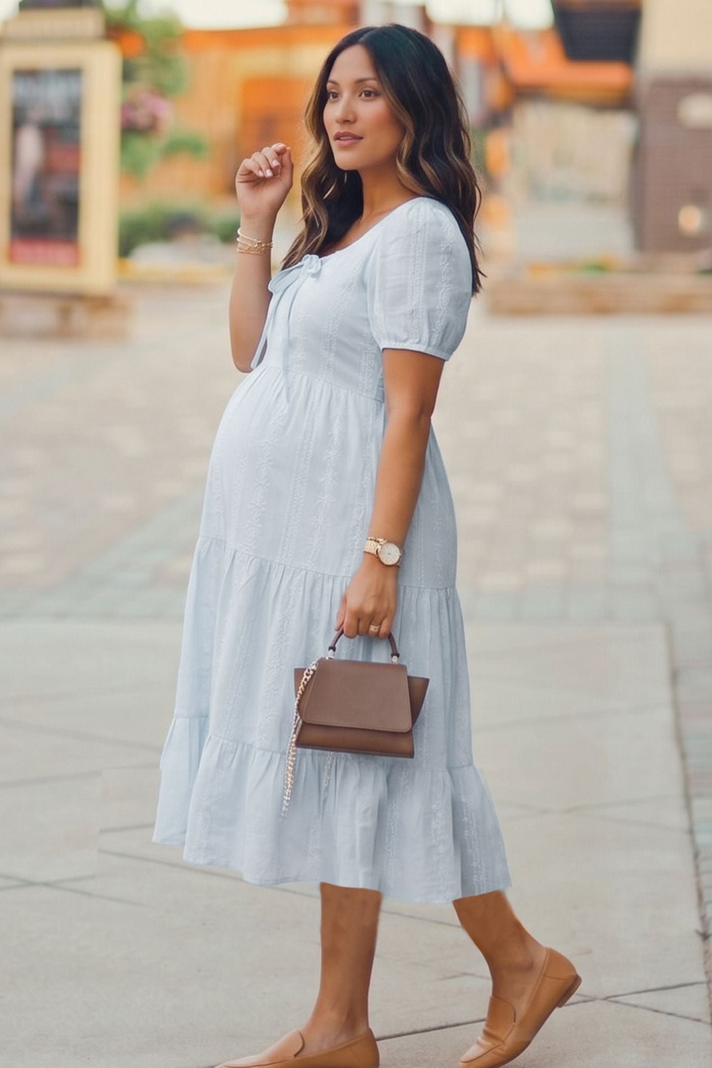 Eyelet Scoop Neck Tiered Maternity Dress in Blue featuring a tiered flounce skirt on a pregnant model, side view.