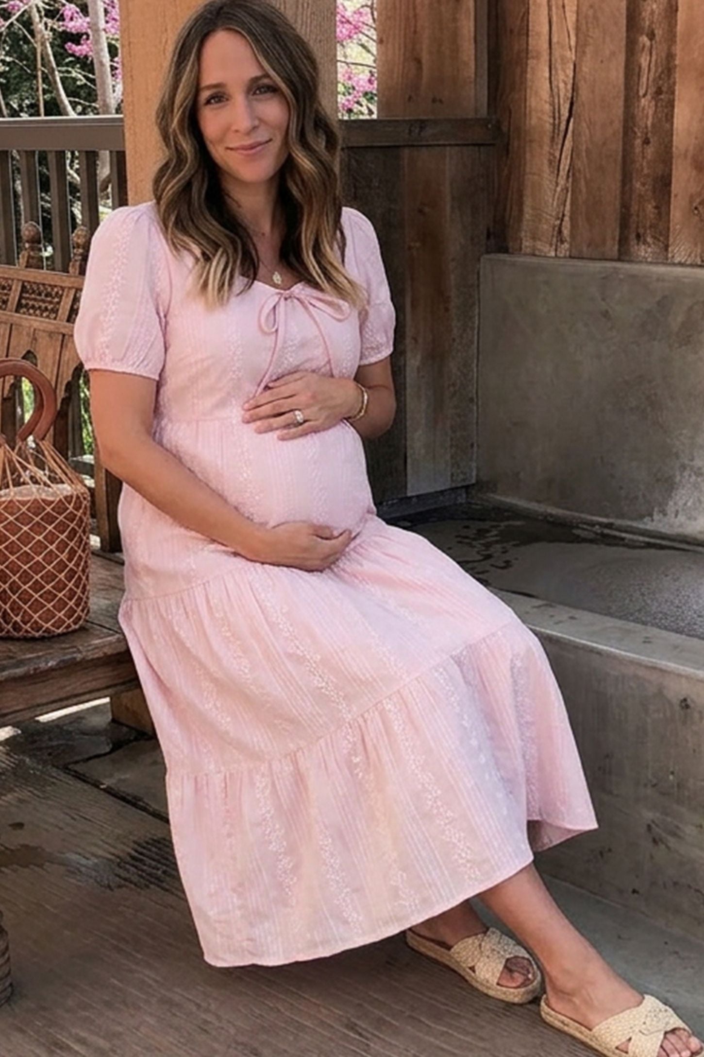 Eyelet Scoop Neck Tiered Maternity Dress Eyelet Scoop Neck Tiered Maternity Dress in Pink featuring a front tie detail on a pregnant model, front view.
