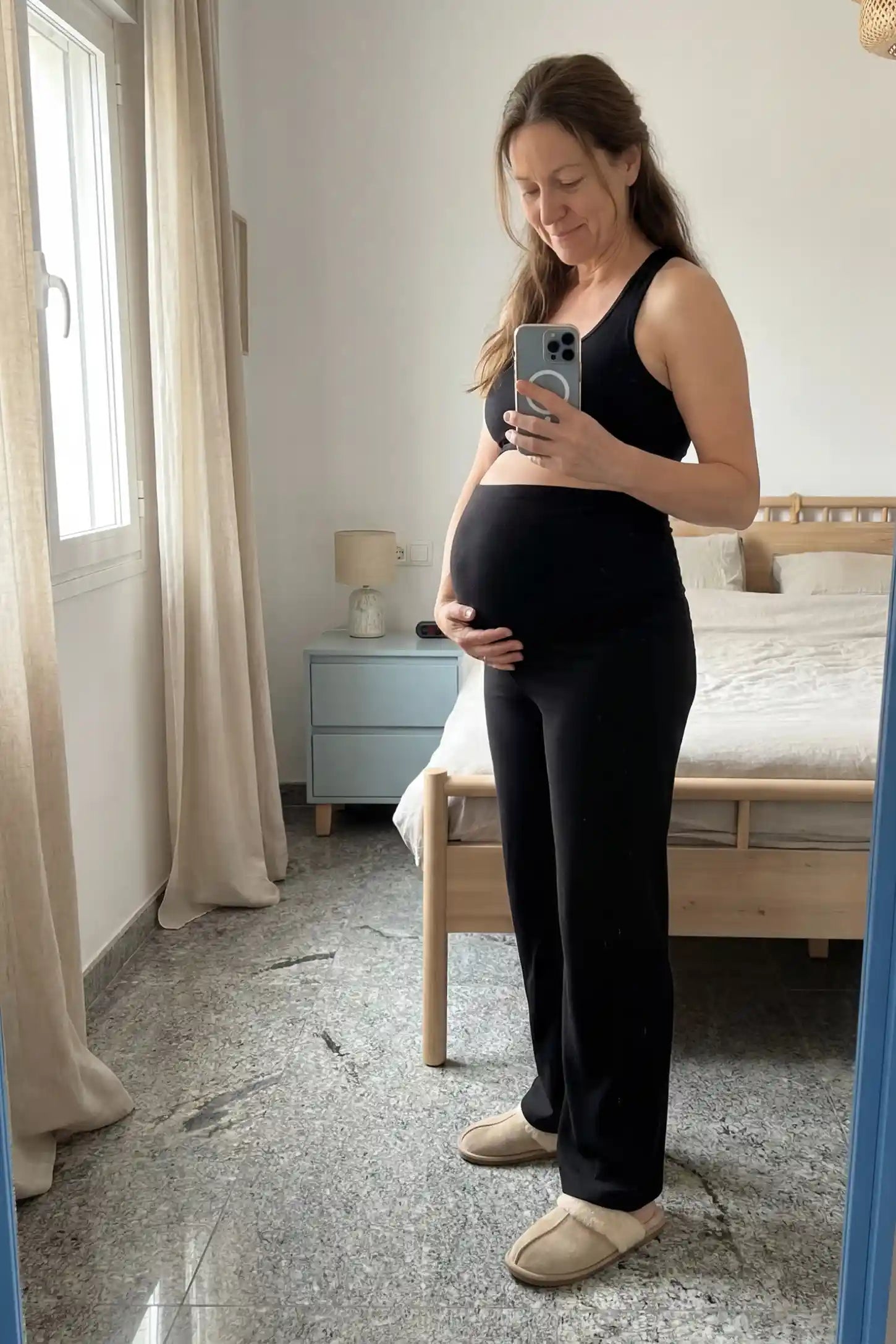 Fleece Straight-Leg Maternity Pants Fleece Straight-Leg Maternity Pants in Black featuring a soft elastic waistband on a pregnant model, front view.