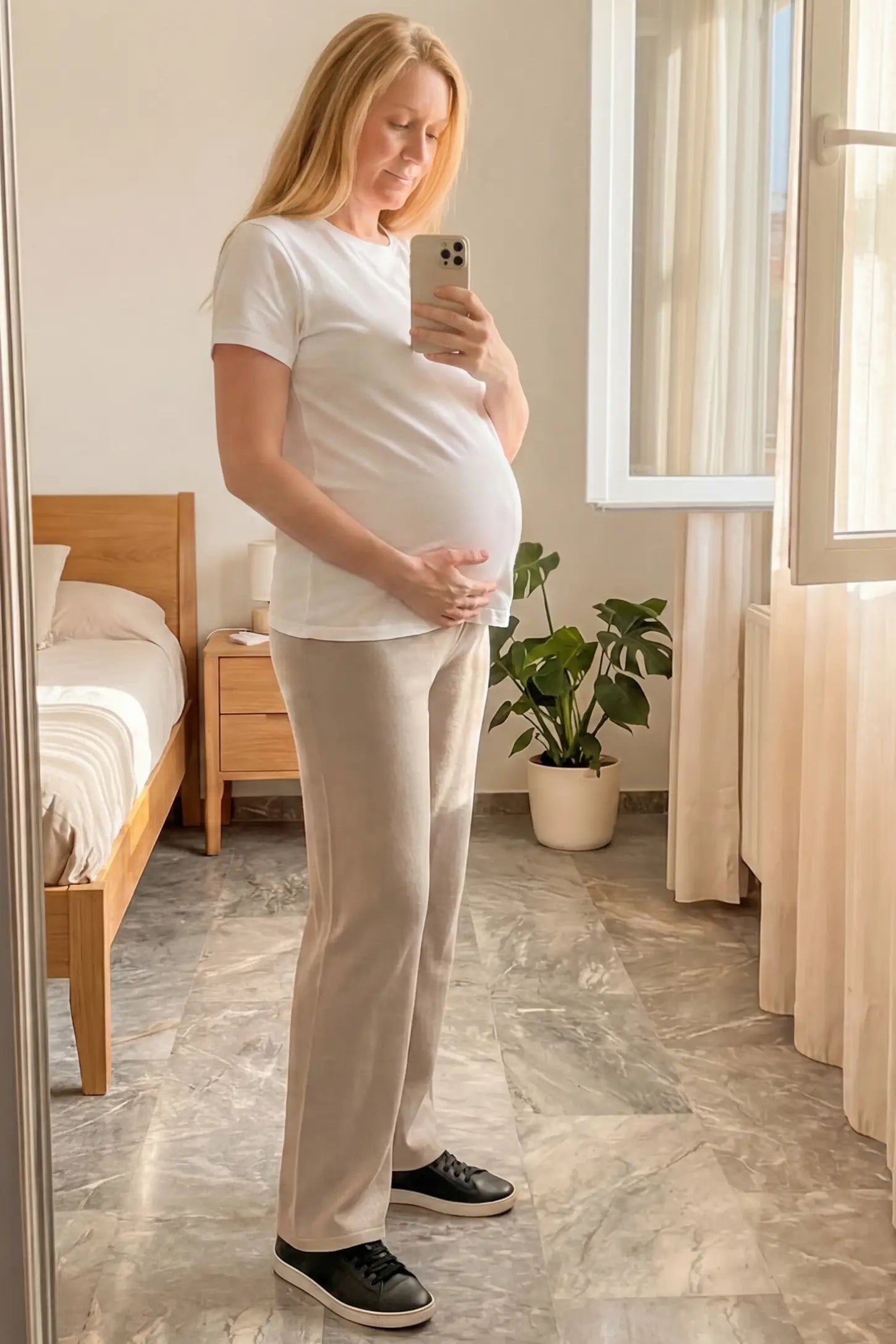 Fleece Straight-Leg Maternity Pants Fleece Straight-Leg Maternity Pants in Off-White featuring a relaxed straight-leg cut on a pregnant model.