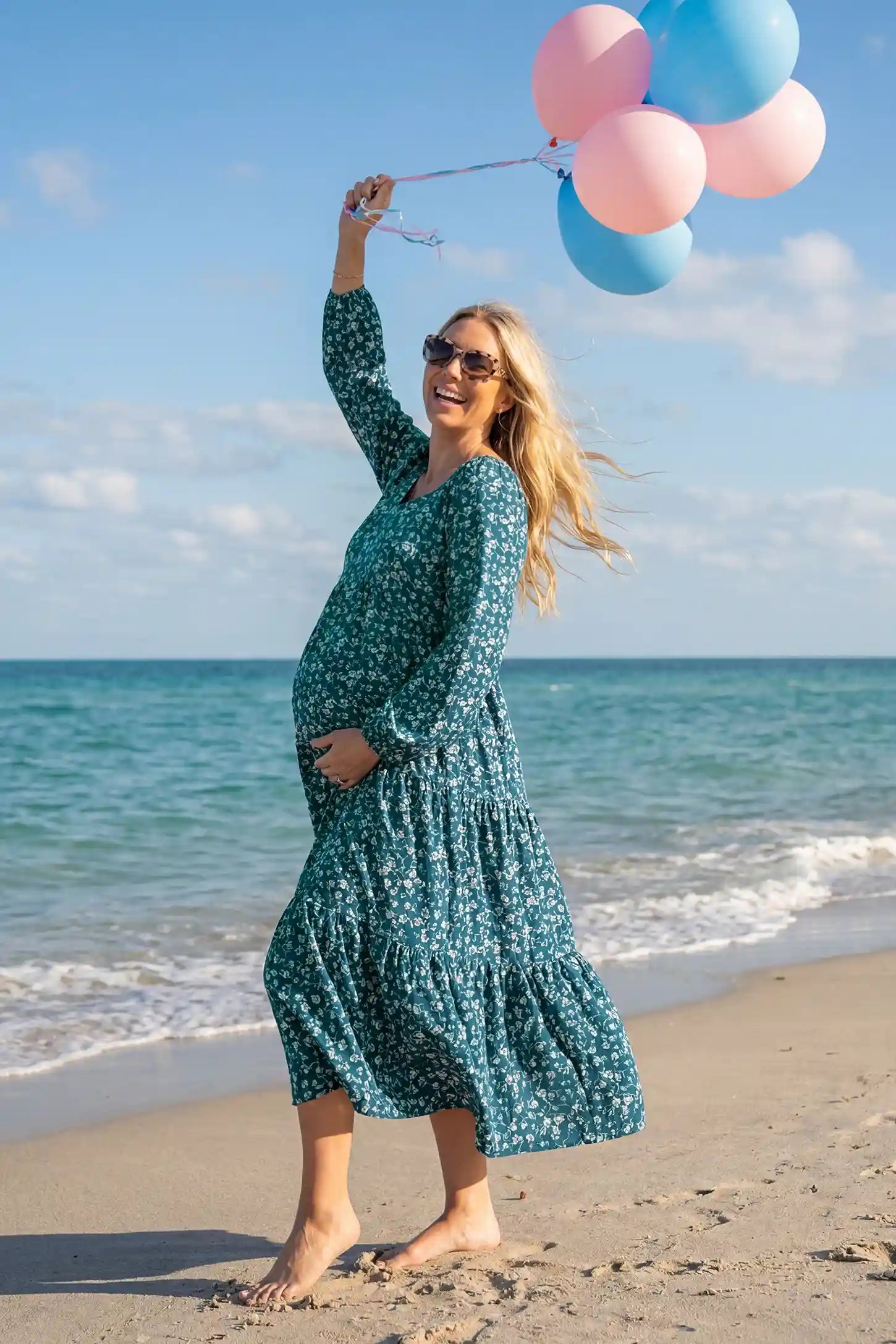 Floral Balloon Sleeves Midi Maternity Dress Blue Floral Balloon Sleeves Midi Maternity Dress featuring a tiered skirt on a front view pregnant model, editorial lifestyle view.