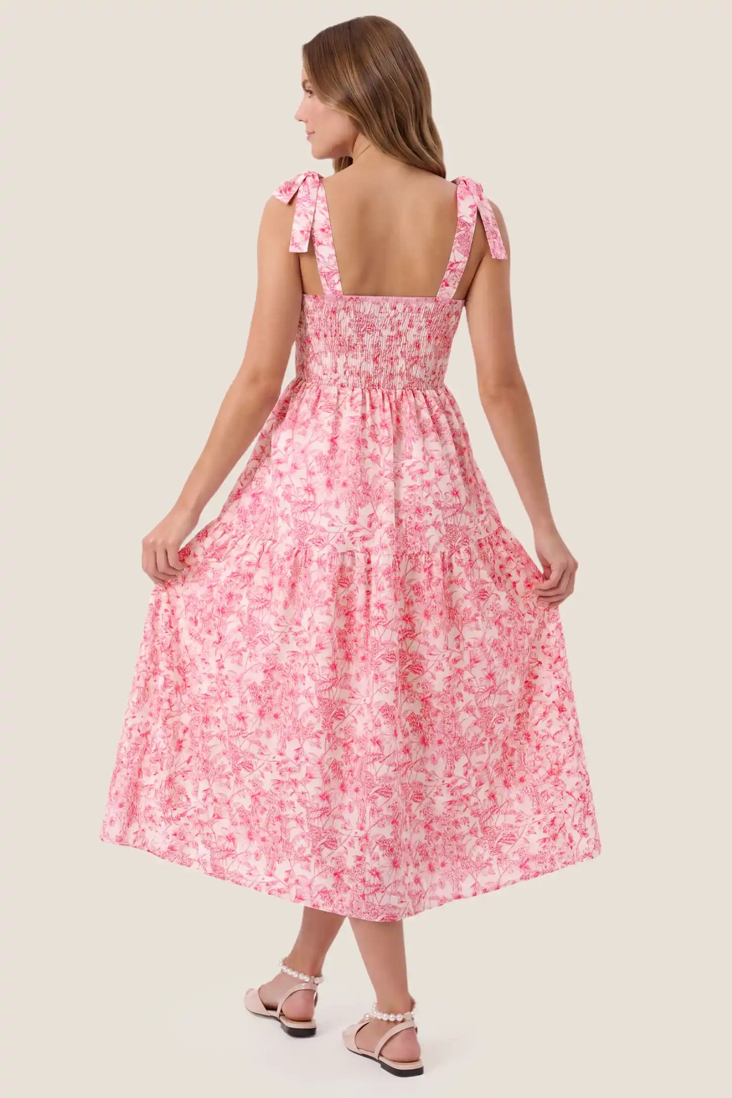 Floral Cami Tiered Maxi Maternity Dress Floral Cami Tiered Maxi Maternity Dress in pink floral highlighting the flowing skirt and adjustable camisole straps, back view on a pregnant model.