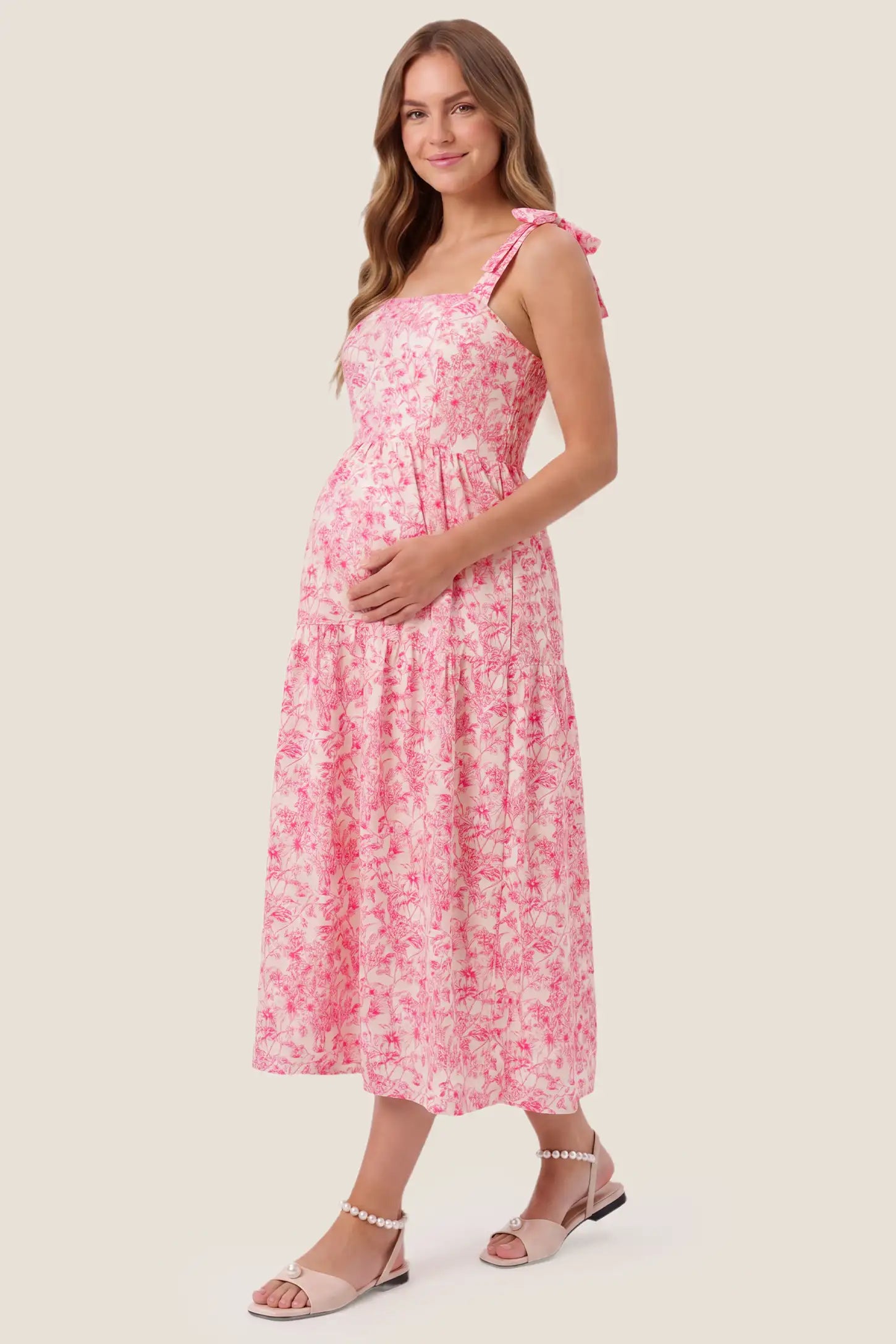 Floral Cami Tiered Maxi Maternity Dress Floral Cami Tiered Maxi Maternity Dress in pink floral with cascading tiers and an open back design, side view on a pregnant model.