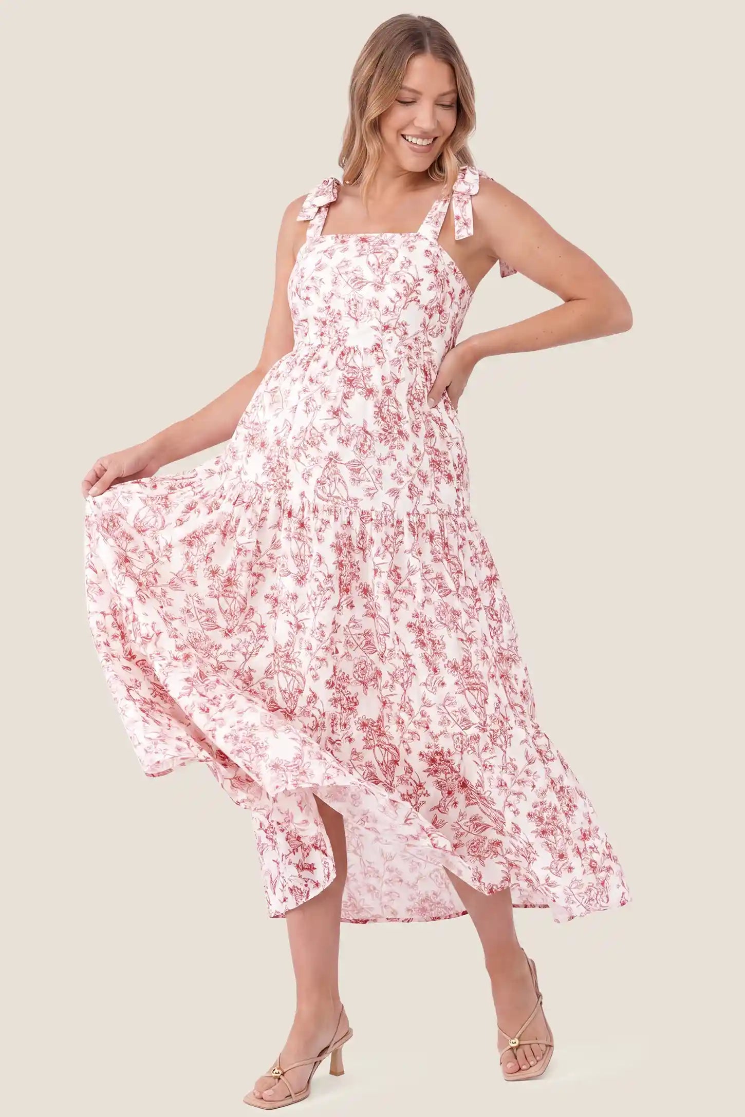 Floral Cami Tiered Maxi Maternity Dress Floral Cami Tiered Maxi Maternity Dress in Rusty French Floral featuring cami straps and a tiered maxi skirt, front view on a pregnant model.