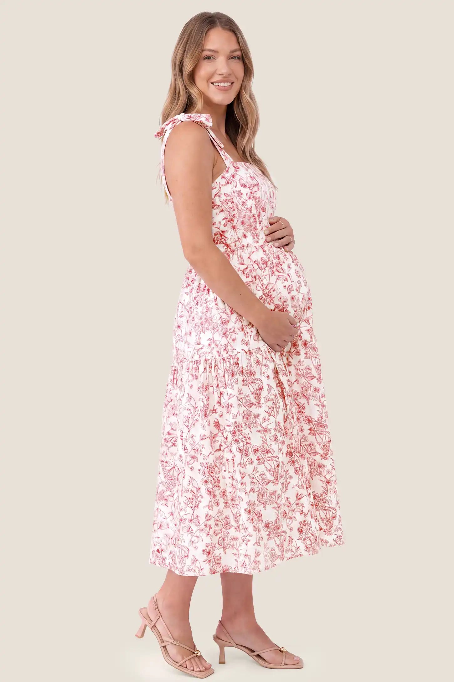 Floral Cami Tiered Maxi Maternity Dress Floral Cami Tiered Maxi Maternity Dress in Rusty French Floral with an accommodating tiered silhouette, side view on a pregnant model.