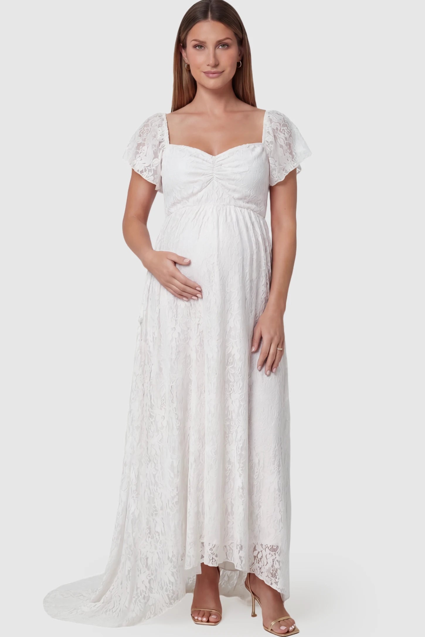 Floral Lace Flutter Sleeve Maternity Maxi Dress Floral Lace Flutter Sleeve Maternity Maxi Dress in White featuring sweetheart neckline on a pregnant model showing front.