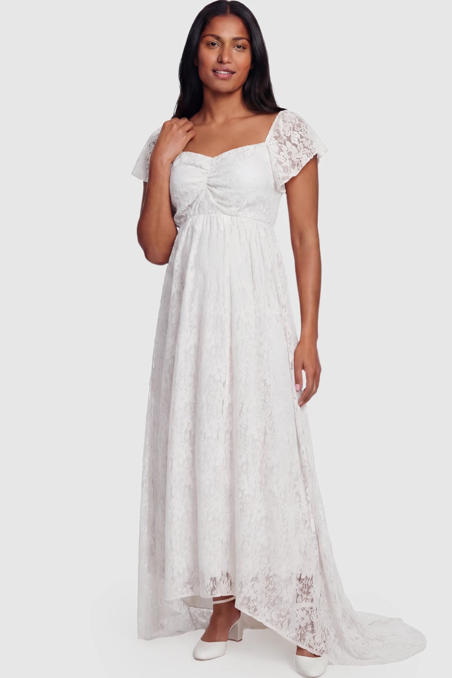 Floral Lace Flutter Sleeve Maternity Maxi Dress Floral Lace Flutter Sleeve Maternity Maxi Dress in White featuring sweetheart neckline on a postpartum model showing front.