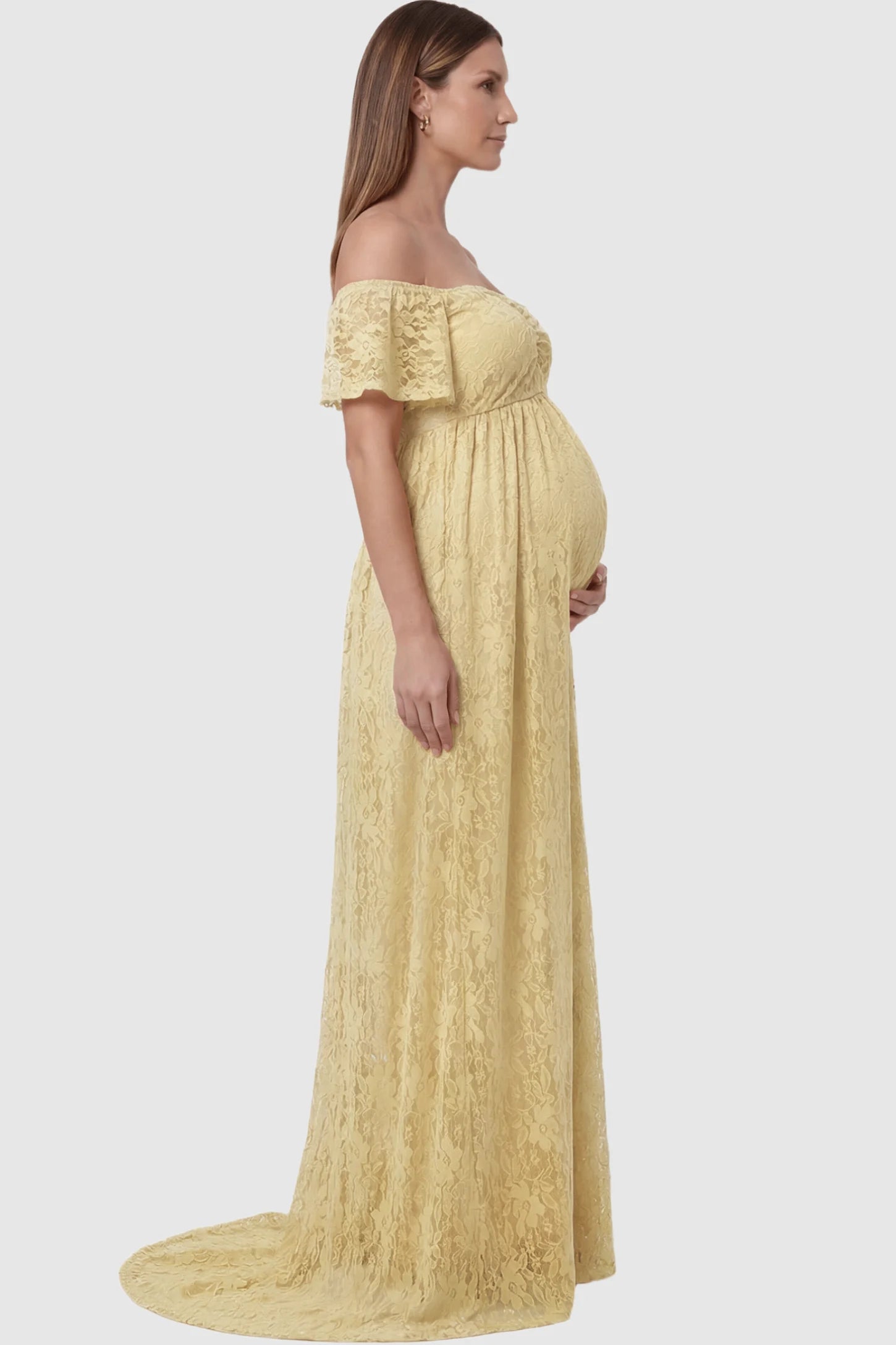Lace Off Shoulder Maternity Maxi Dress Lace Off Shoulder Maternity Maxi Dress in Apricot featuring off the shoulder neckline on a pregnant model showing side.