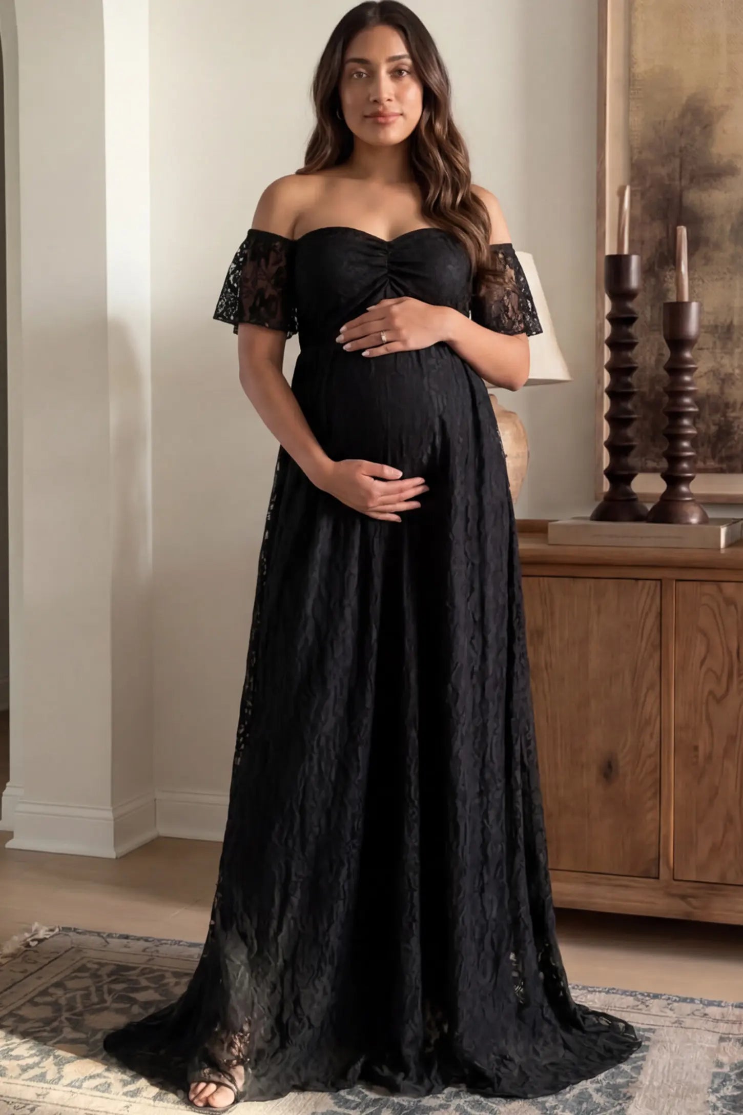 Lace Off Shoulder Maternity Maxi Dress Lace Off Shoulder Maternity Maxi Dress in Black featuring off the shoulder neckline on a pregnant woman showing front.