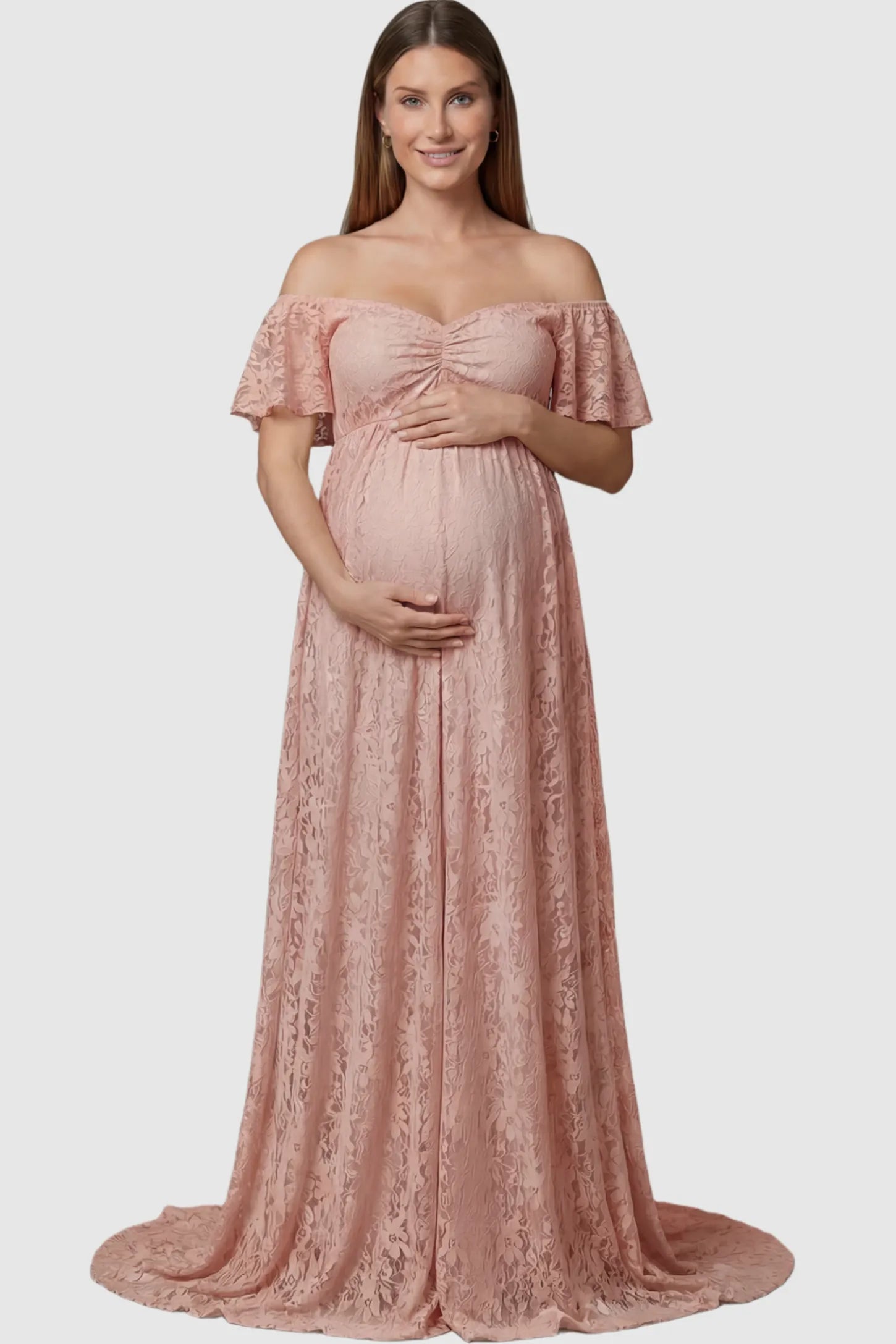 Lace Off Shoulder Maternity Maxi Dress Lace Off Shoulder Maternity Maxi Dress in blush pink featuring off the shoulder neckline on a pregnant model showing front.