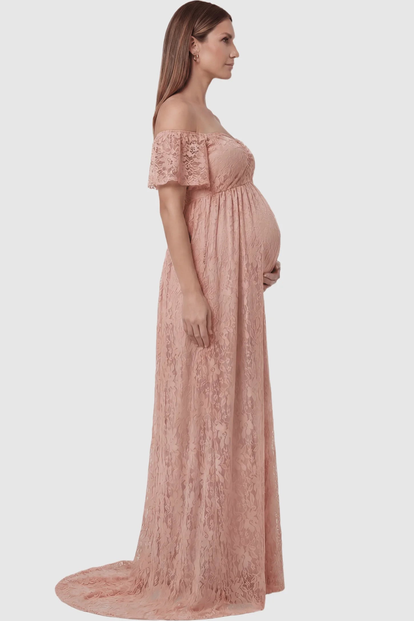 Lace Off Shoulder Maternity Maxi Dress Lace Off Shoulder Maternity Maxi Dress in pink featuring off the shoulder neckline on a pregnant model showing side.
