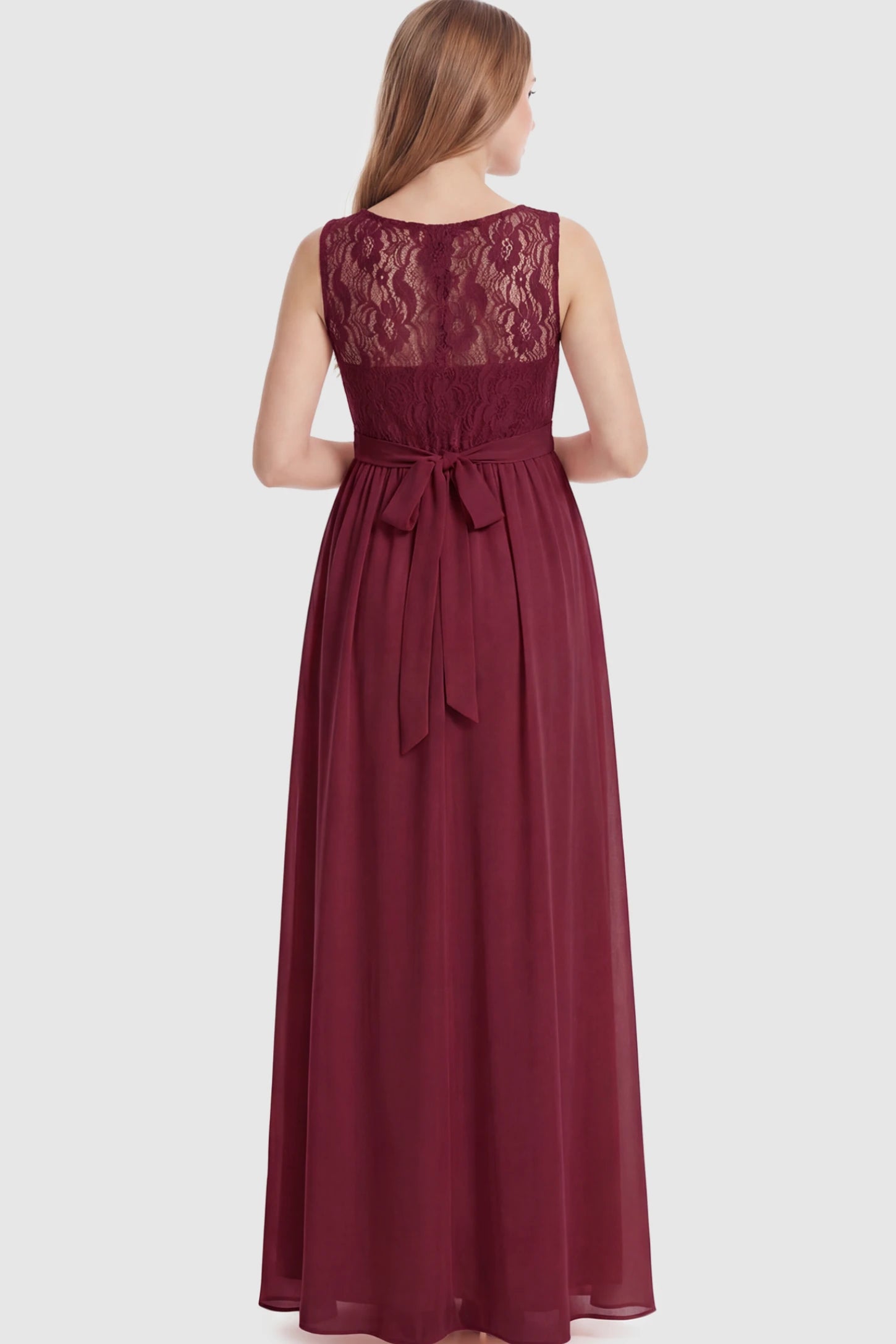 Floral Lace Sleeveless Maternity Maxi Dress Floral Lace Sleeveless Maternity Maxi Dress in Burgundy featuring a flowing skirt on a pregnant model showing back.
