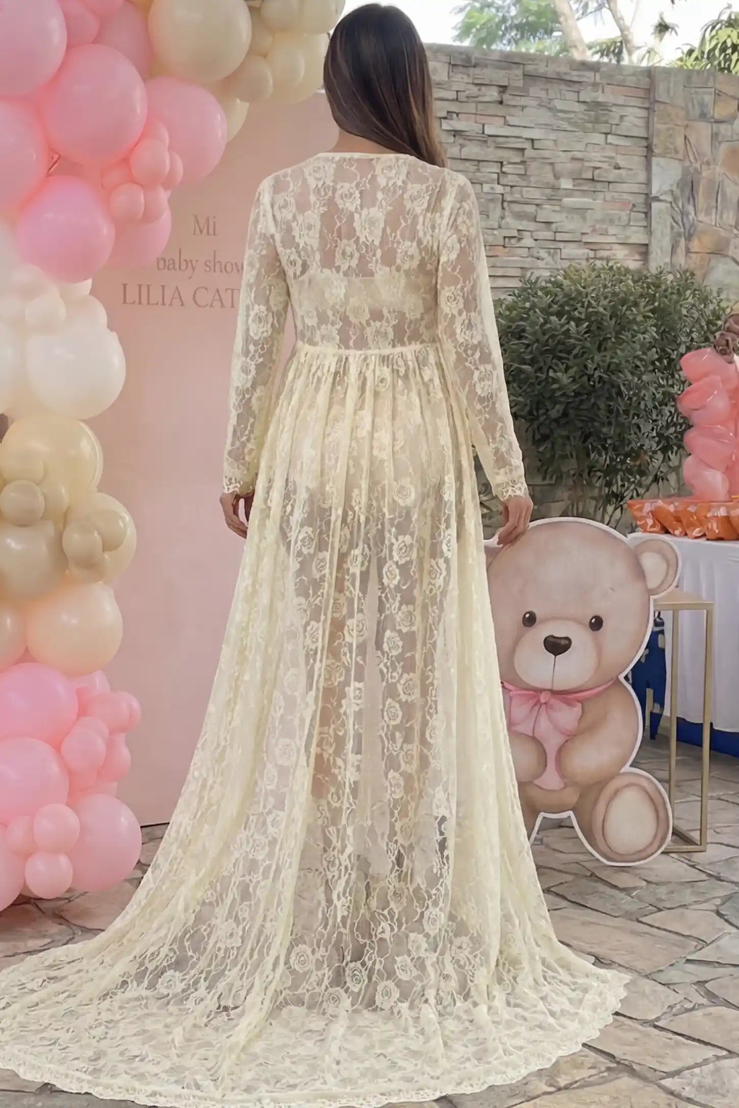 Floral Lace V-Neck Long Sleeve Maternity Photoshoot Gown Floral Lace V-Neck Long Sleeve Maternity Photoshoot Gown in Apricot featuring floor-length lace train on a pregnant model showing back.
