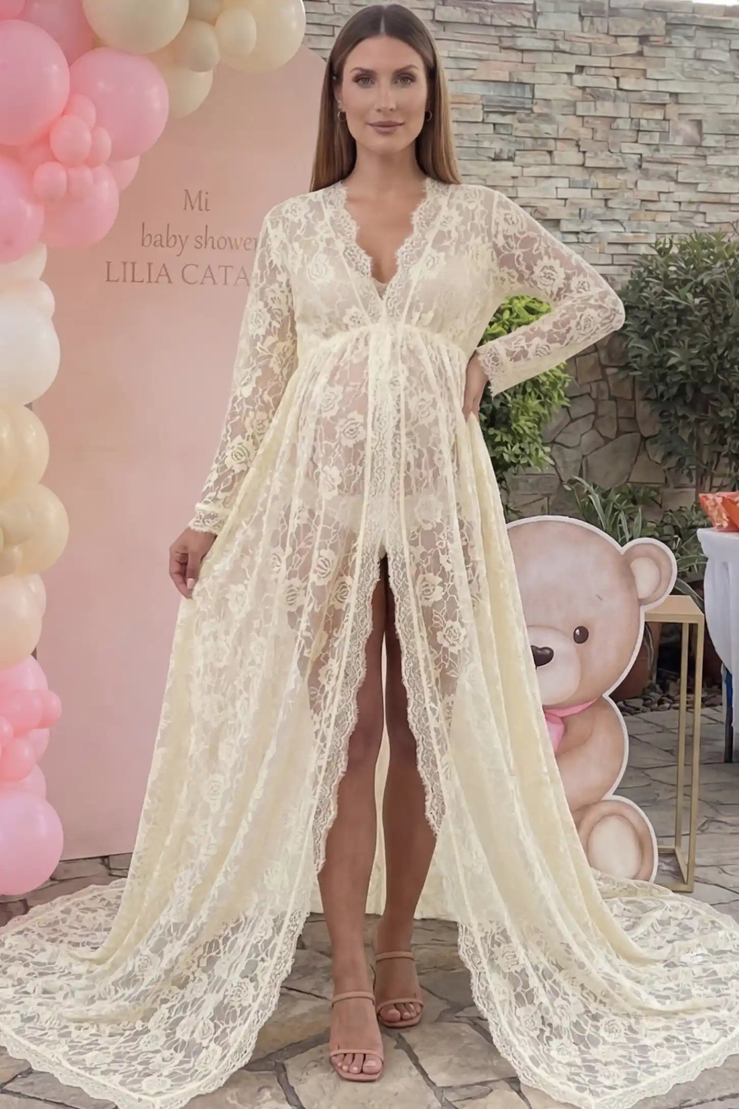 Floral Lace V-Neck Long Sleeve Maternity Photoshoot Gown Floral Lace V-Neck Long Sleeve Maternity Photoshoot Gown in Apricot featuring long sleeves and high front slit on a pregnant model posing front.