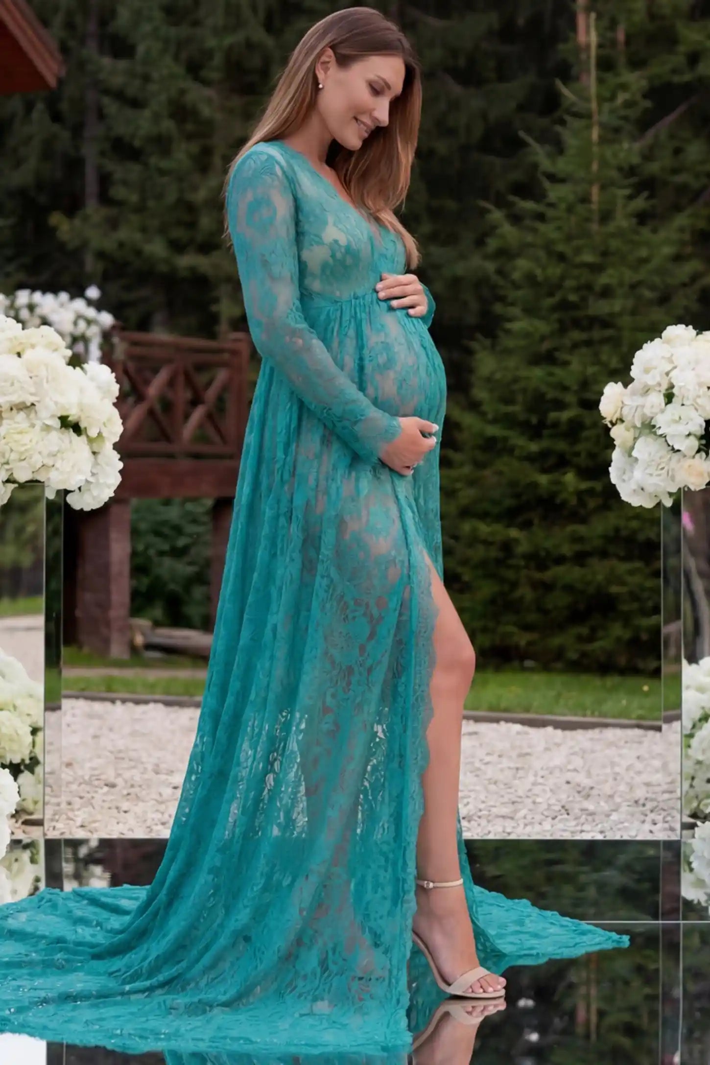 Floral Lace V-Neck Long Sleeve Maternity Photoshoot Gown Floral Lace V-Neck Long Sleeve Maternity Photoshoot Gown in Green featuring long sleeves and high front slit on a pregnant model showing side.