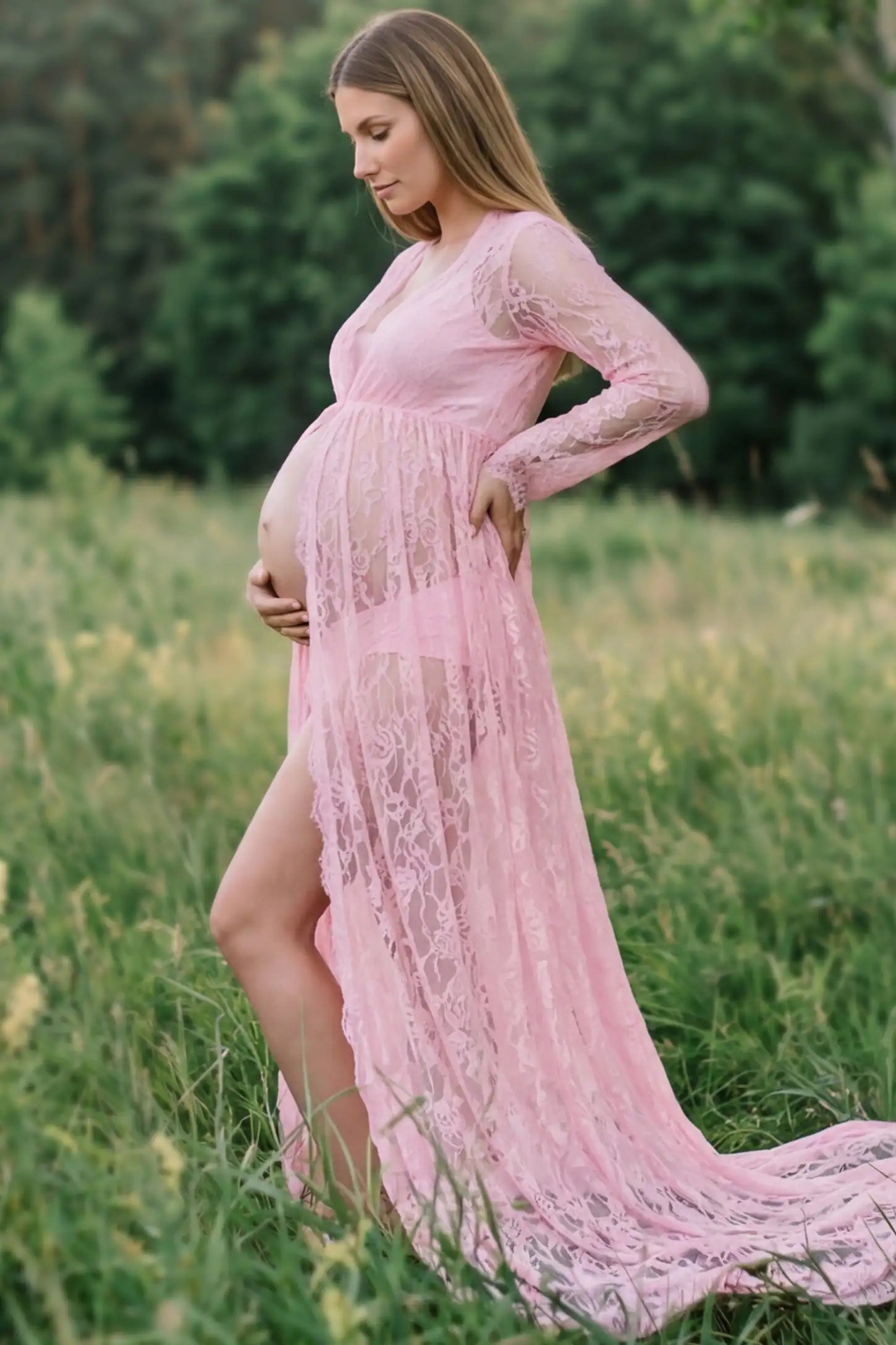 Floral Lace V-Neck Long Sleeve Maternity Photoshoot Gown Floral Lace V-Neck Long Sleeve Maternity Photoshoot Gown in Pink featuring long sleeves and high front slit on a pregnant model showing side.