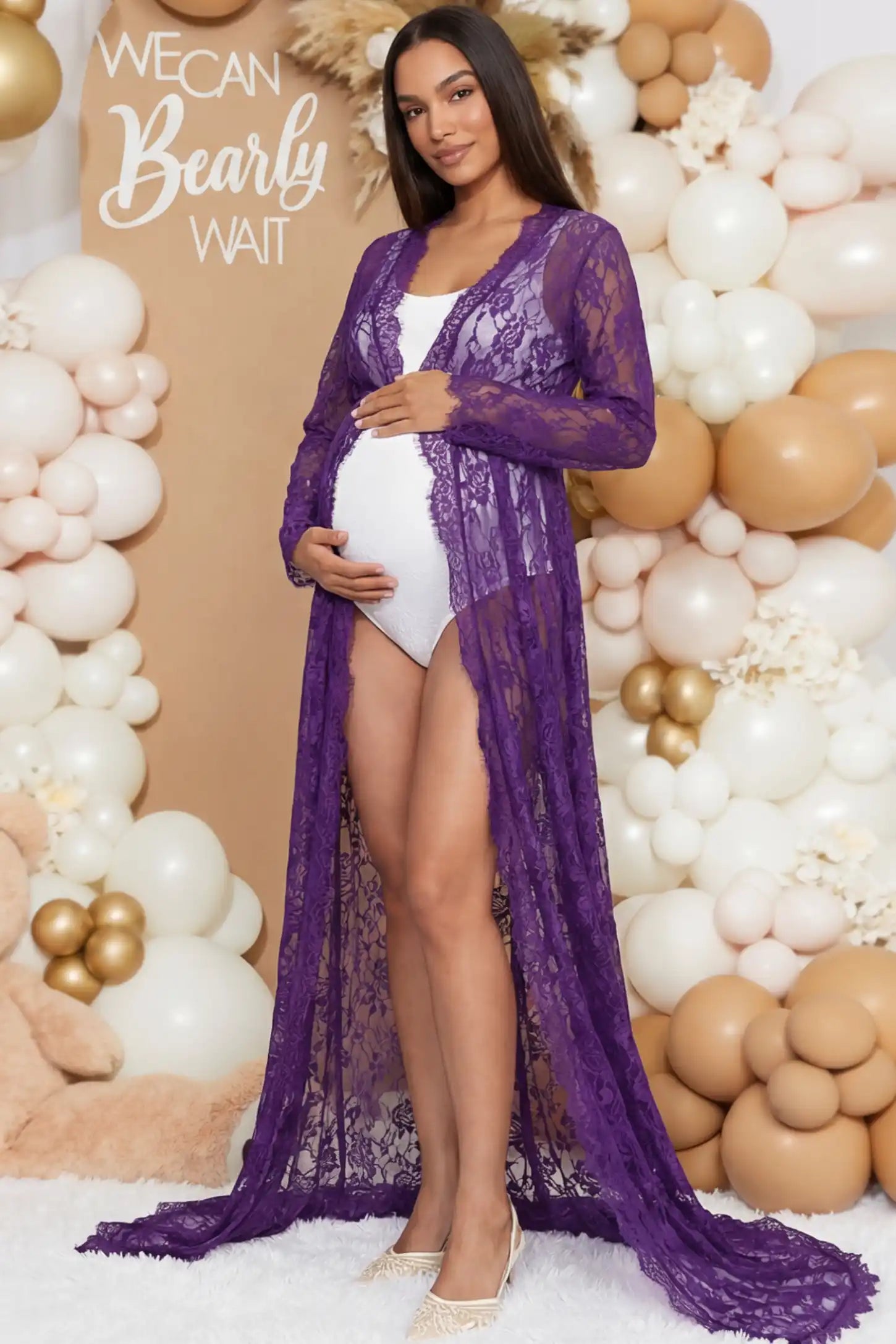 Floral Lace V-Neck Long Sleeve Maternity Photoshoot Gown Floral Lace V-Neck Long Sleeve Maternity Photoshoot Gown in Purple featuring long sleeves and high front slit on a pregnant woman during home photoshoot.