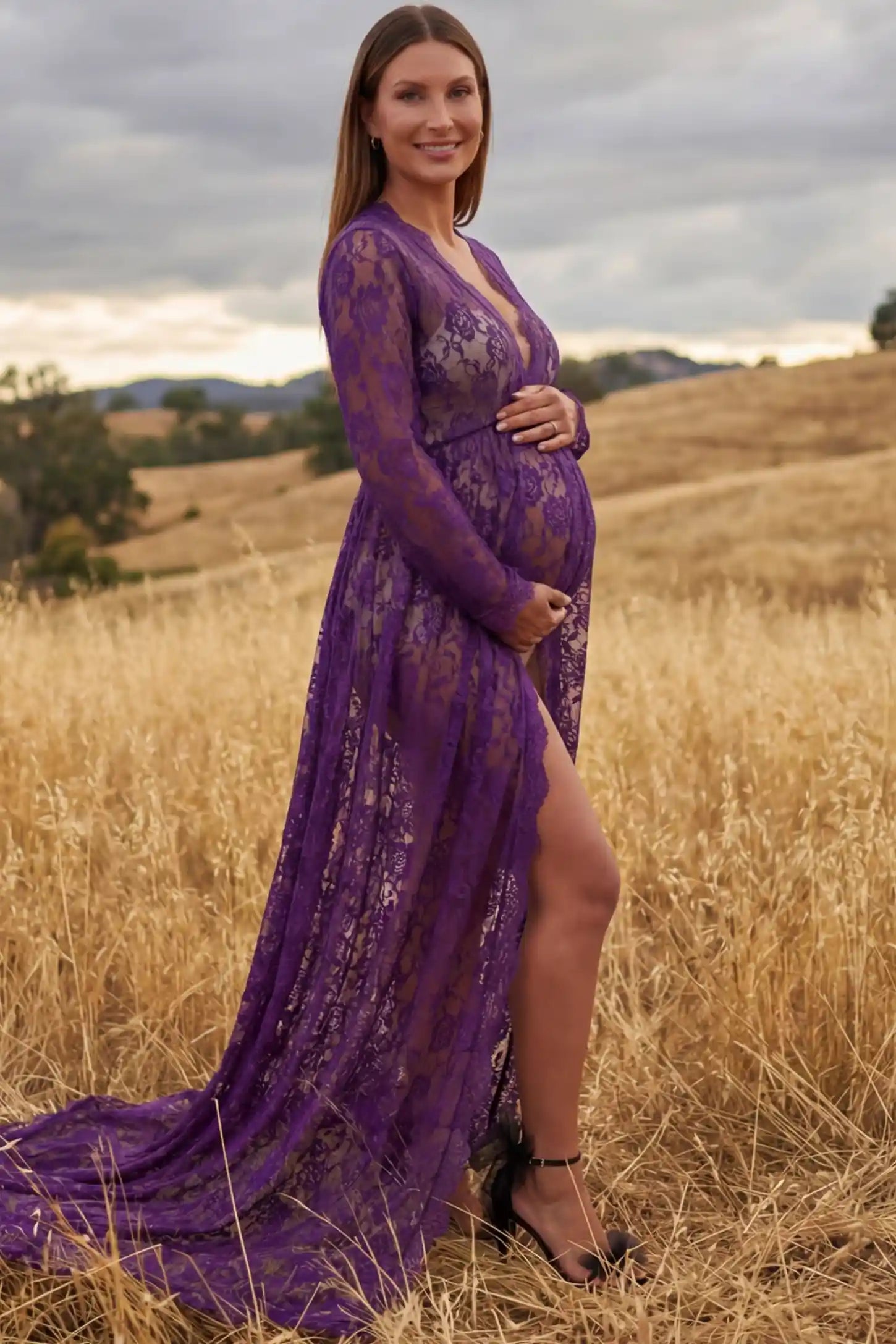 Floral Lace V-Neck Long Sleeve Maternity Photoshoot Gown Floral Lace V-Neck Long Sleeve Maternity Photoshoot Gown in Purple featuring long sleeves and high front slit on a pregnant model showing side.