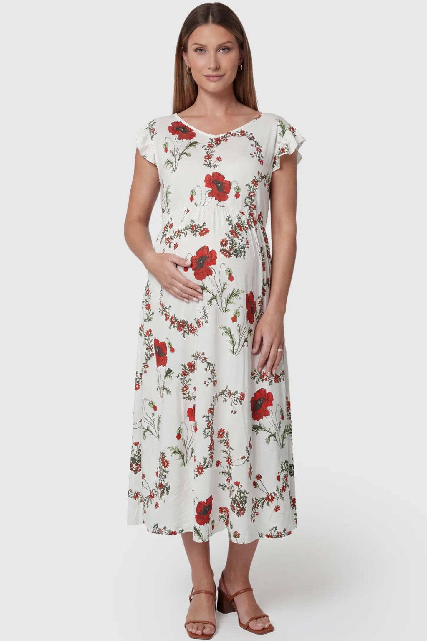 Floral Print Scoop Neck Maxi Maternity Dress in White with Red Poppy Prints featuring ruffle sleeves on a pregnant model front view.