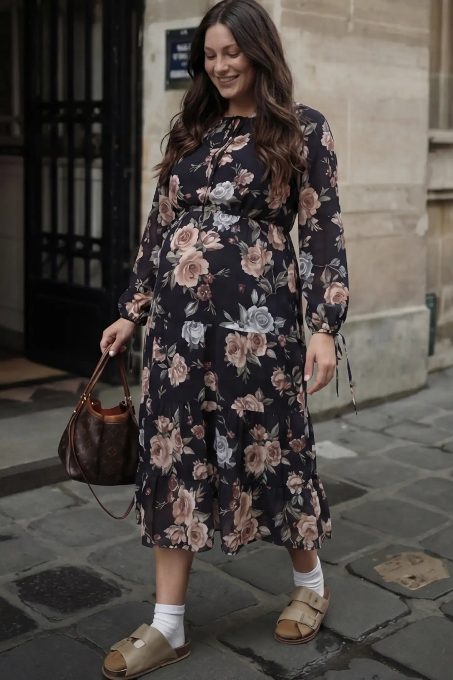 Floral Print Tiered Midi Maternity Dress in dark floral featuring adjustable tie-cuff sleeves on a pregnant woman.