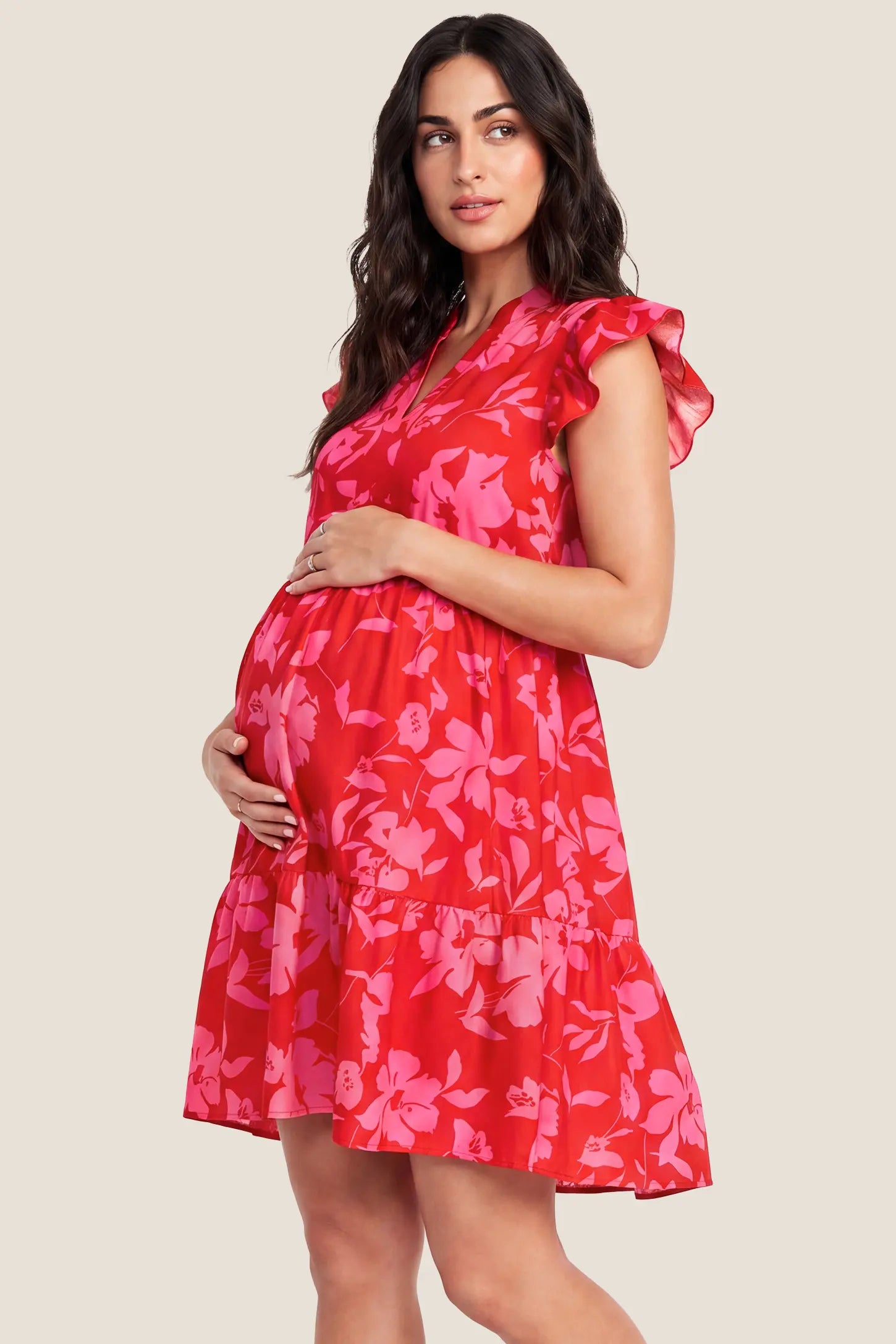 Floral Print V-Neck Flutter Sleeve Maternity Short Dress Floral Print V-Neck Flutter Sleeve Maternity Short Dress in Poppy Red with a relaxed silhouette, side view on a pregnant model.