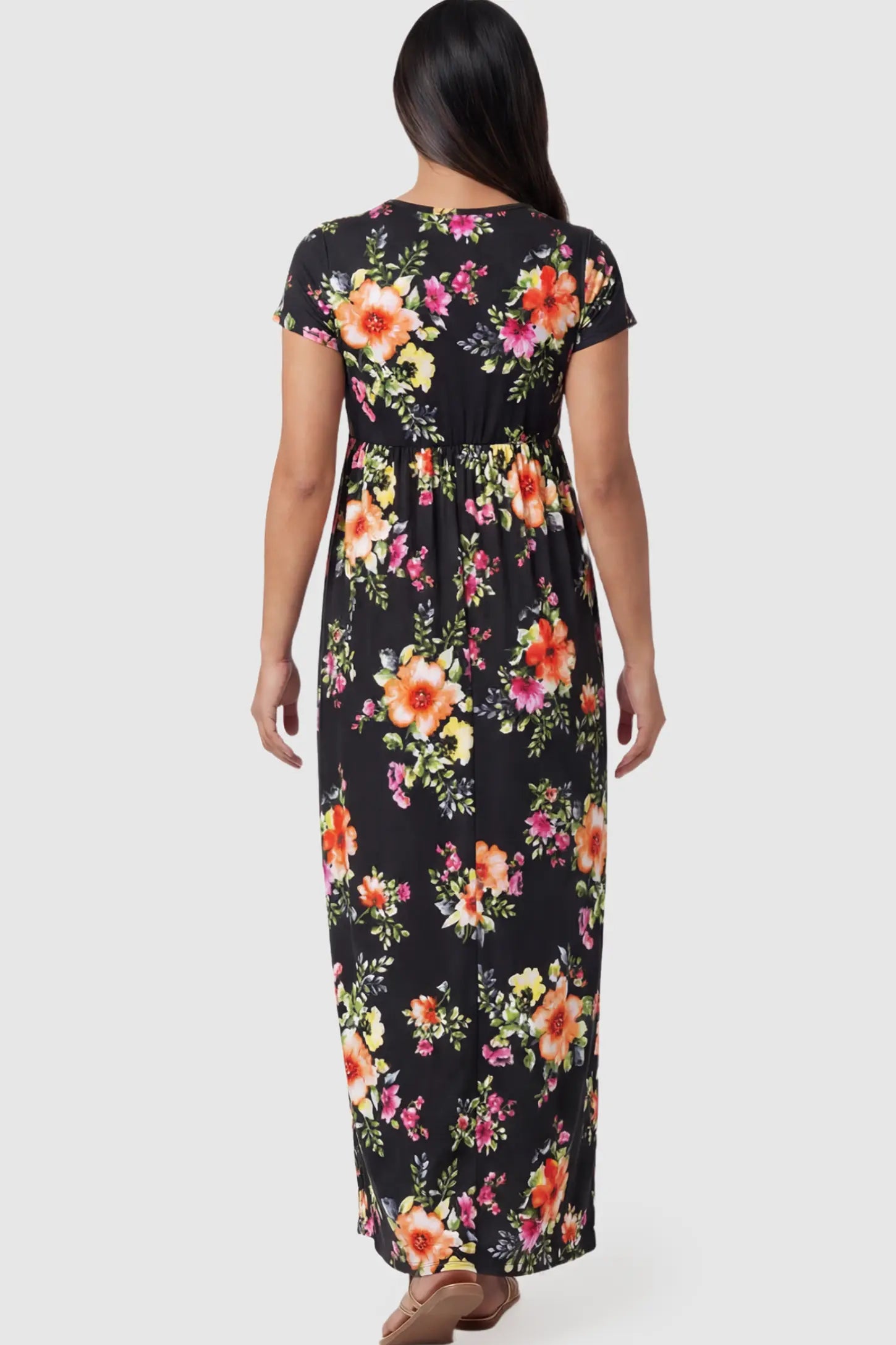 Floral Print V-Neck Maternity Maxi Dress Floral Print V-Neck Maternity Maxi Dress in Black featuring a vibrant floral pattern on a pregnant model showing back.