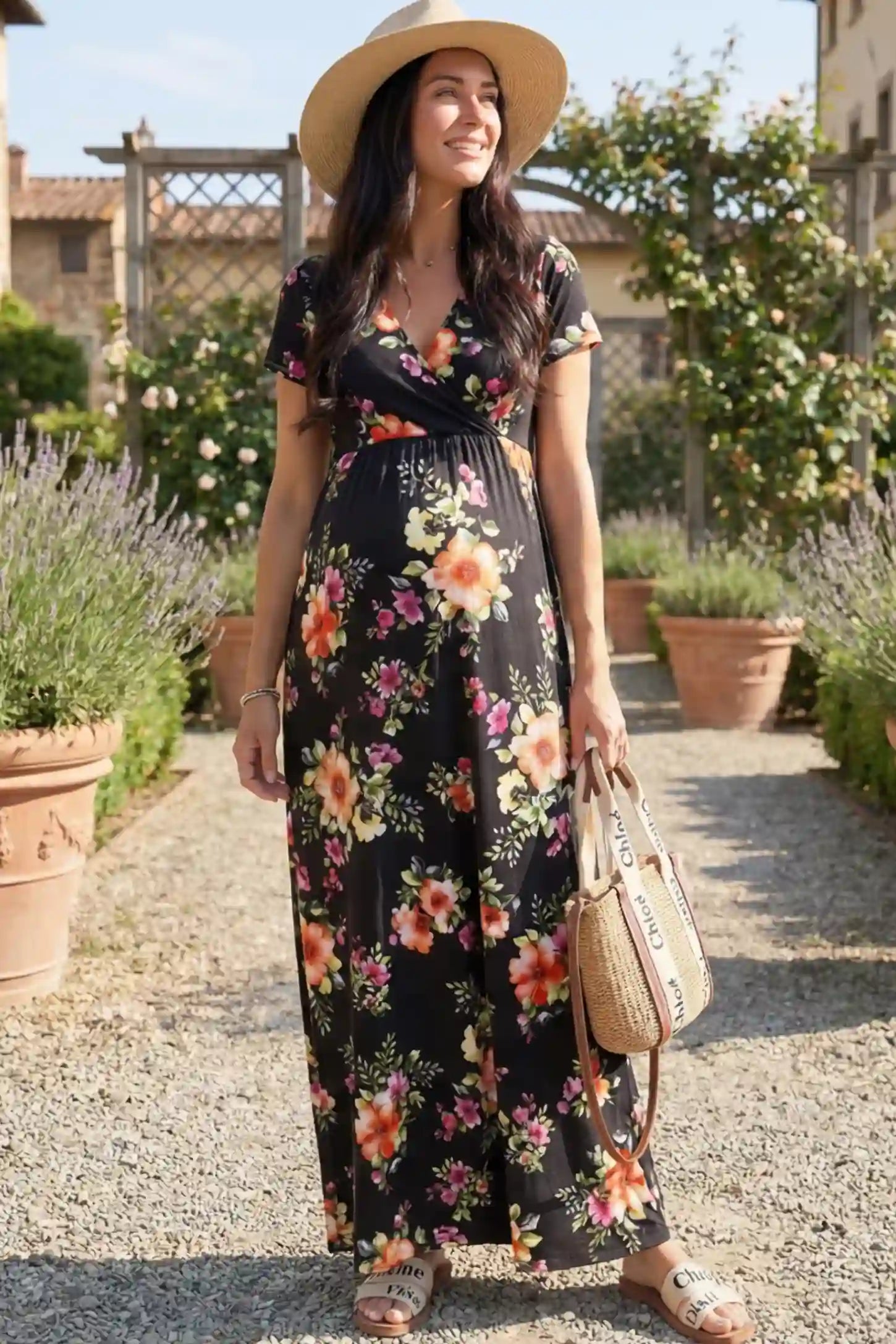 Floral Print V-Neck Maternity Maxi Dress Floral Print V-Neck Maternity Maxi Dress in Black featuring a vibrant floral pattern on a pregnant woman showing front.