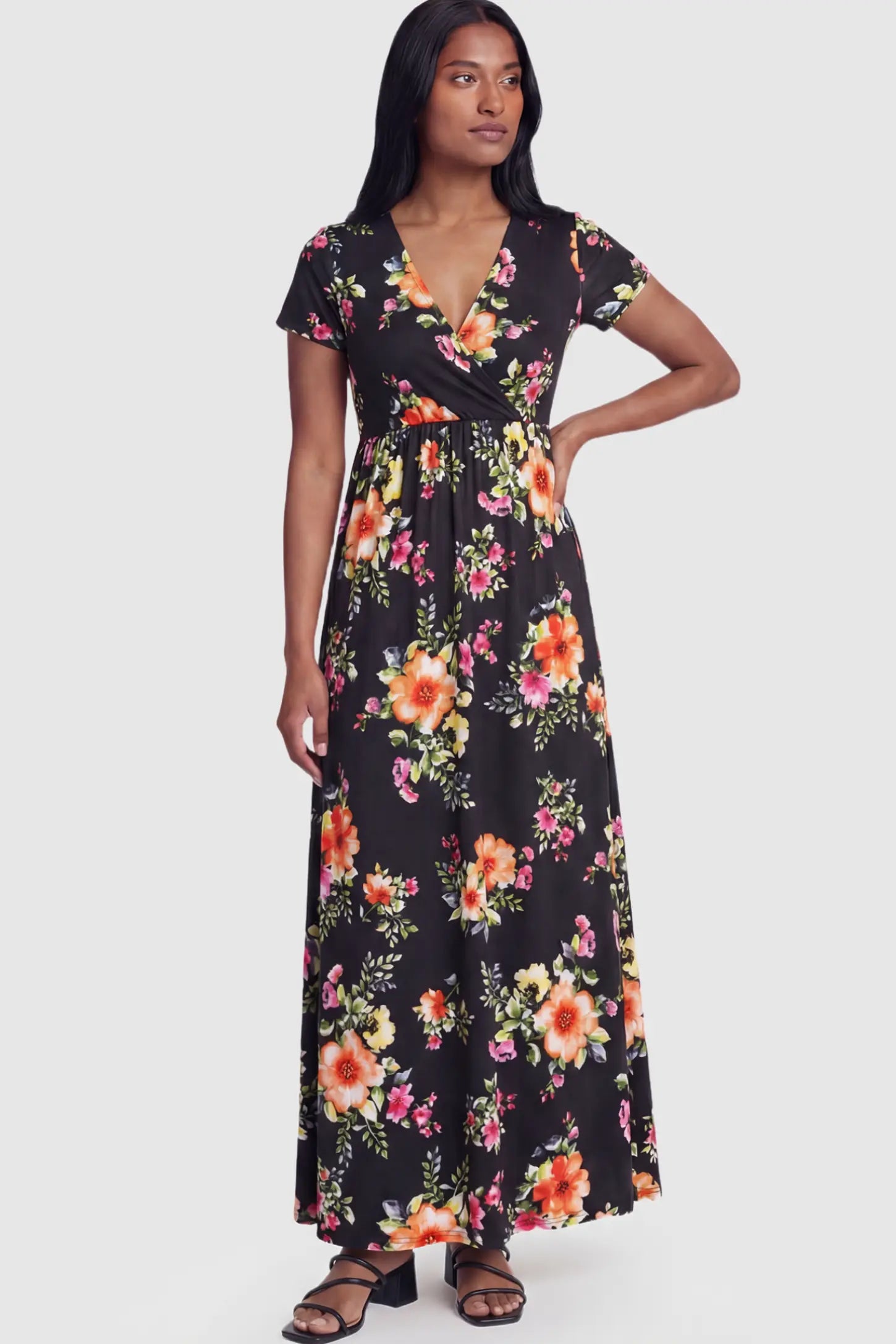 Floral Print V-Neck Maternity Maxi Dress Floral Print V-Neck Maternity Maxi Dress in Black featuring a vibrant floral pattern on a postpartum model showing front.