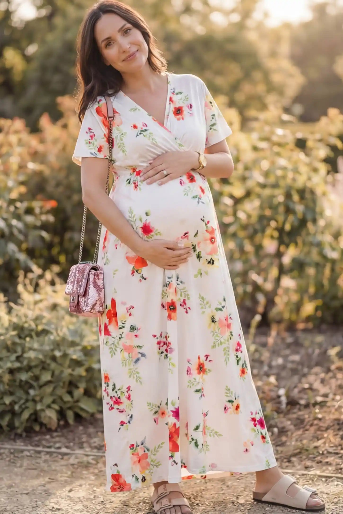 Floral Print V-Neck Maternity Maxi Dress in White featuring a vibrant floral pattern on a pregnant woman showing front.