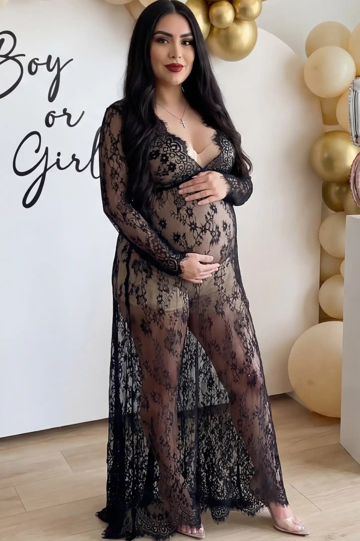 Floral Sheer Lace Maternity Gown in Black featuring scalloped v-neck and long sleeves on a pregnant woman showing front.