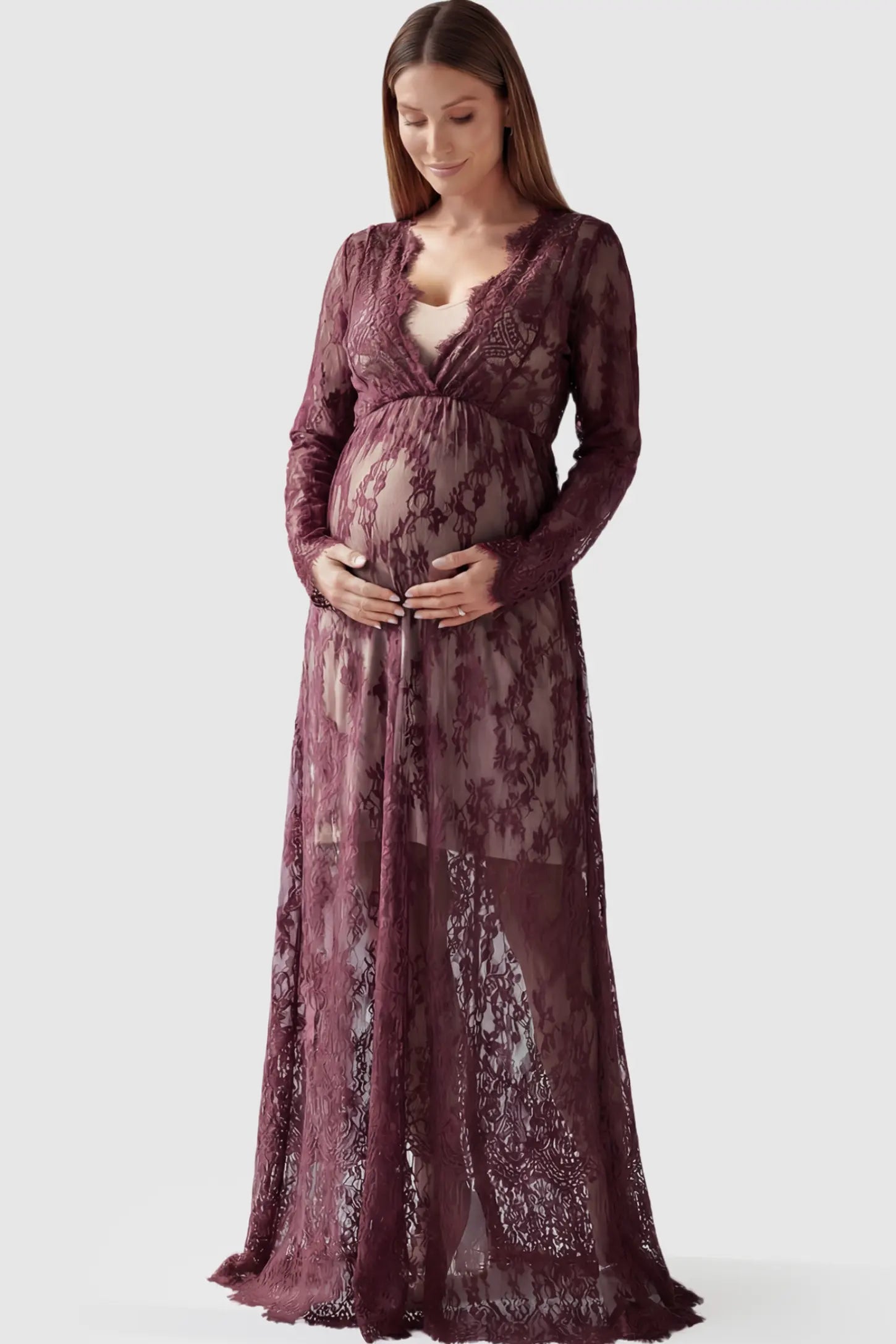 Floral Sheer Lace Long Sleeve Maternity Photoshoot Gown Floral Sheer Lace Maternity Gown in Burgundy featuring scalloped v-neck and long sleeves on a pregnant model showing front.