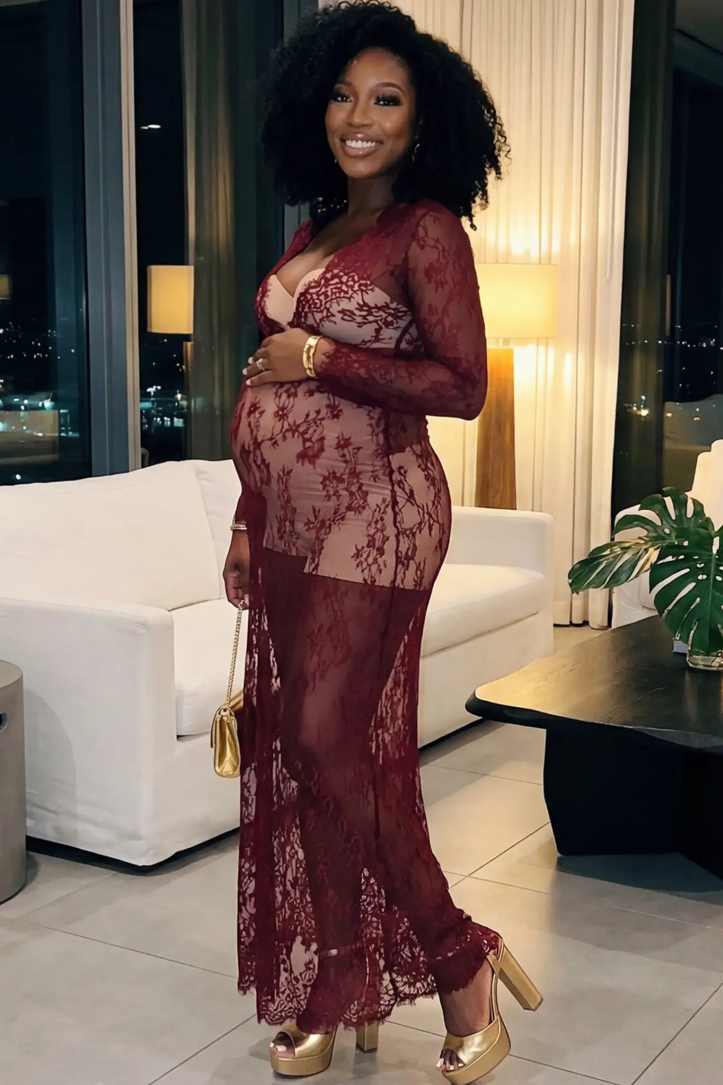 Floral Sheer Lace Long Sleeve Maternity Photoshoot Gown Floral Sheer Lace Maternity Gown in Burgundy featuring scalloped v-neck and long sleeves on a pregnant woman showing side.