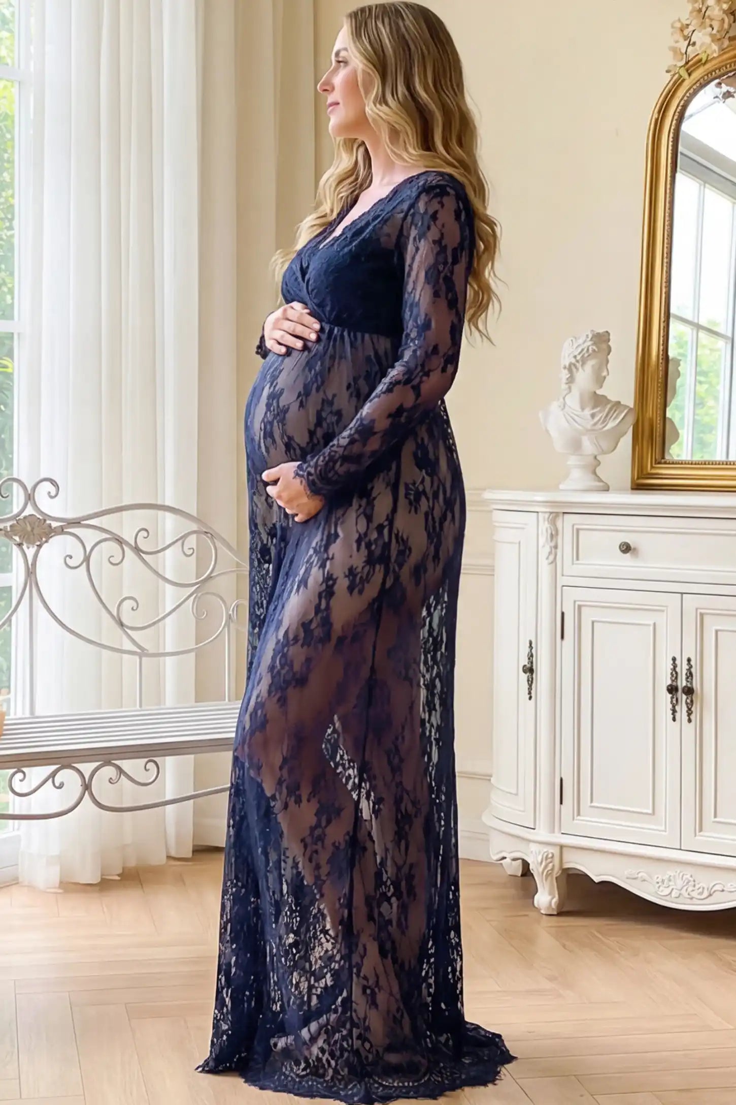 Floral Sheer Lace Long Sleeve Maternity Photoshoot Gown Floral Sheer Lace Maternity Gown in Dark Blue featuring scalloped v-neck and long sleeves on a pregnant woman showing side.