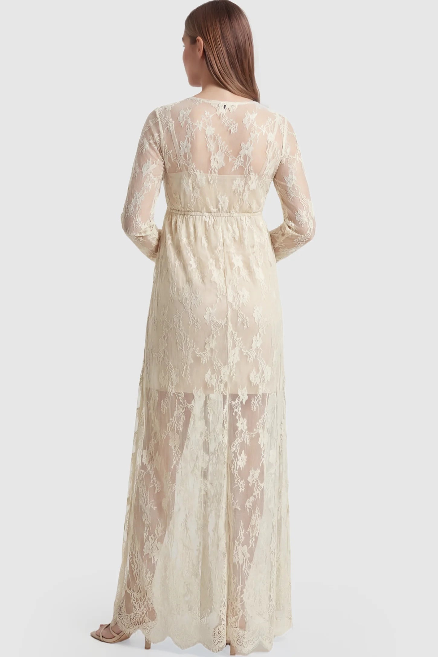 Floral Sheer Lace Long Sleeve Maternity Photoshoot Gown Floral Sheer Lace Maternity Gown in Ivory featuring long sleeves on a pregnant model showing back.