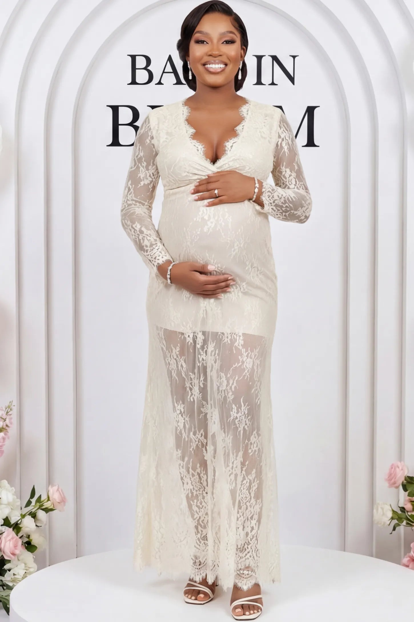 Floral Sheer Lace Long Sleeve Maternity Photoshoot Gown Floral Sheer Lace Maternity Gown in Ivory featuring scalloped v-neck and long sleeves on a pregnant woman showing front.